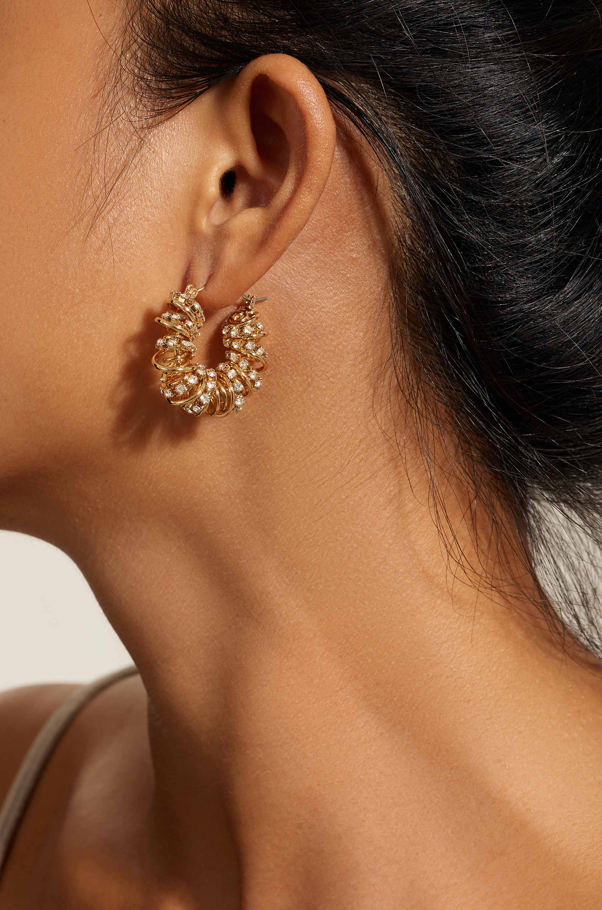 Swirling Crystal Cluster Hoop Earrings on model