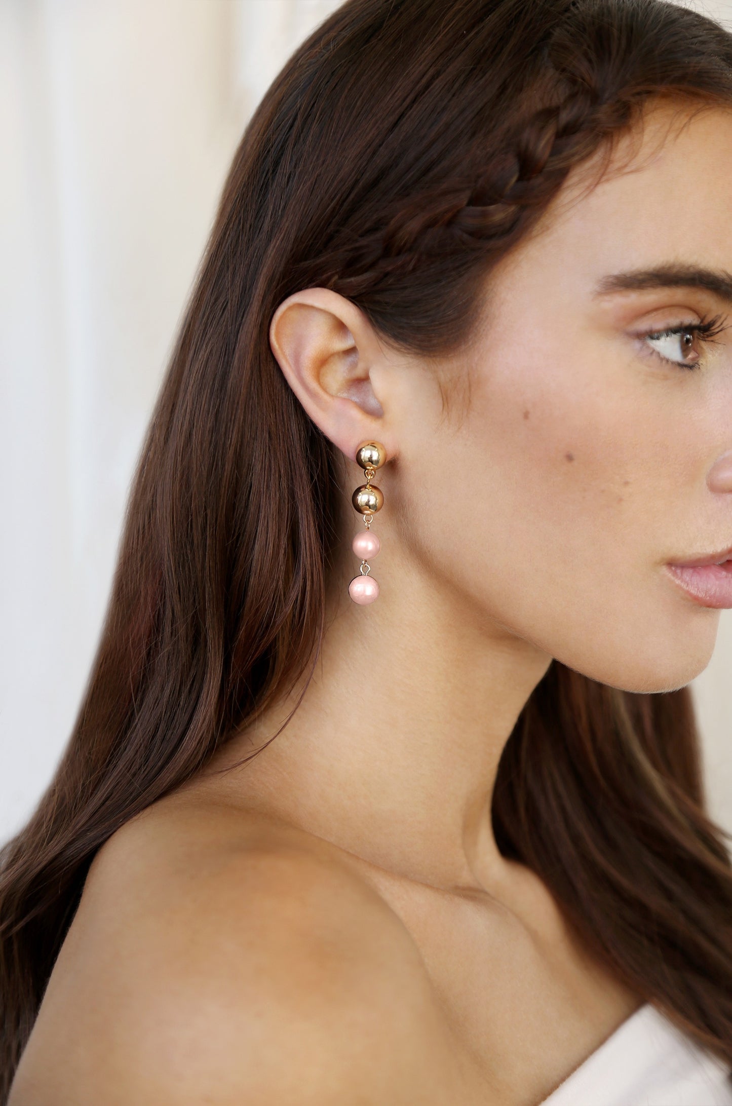 Resort Drop Earrings in pink pearl on model 2