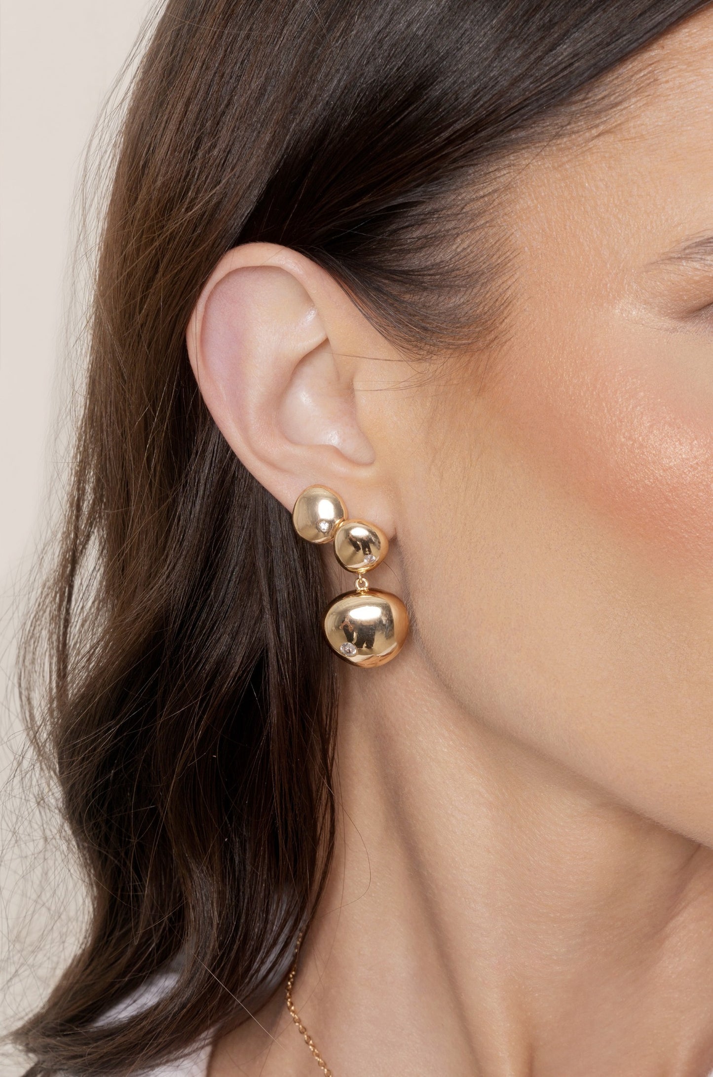 Polished Double Pebble Drop Earrings on gold model