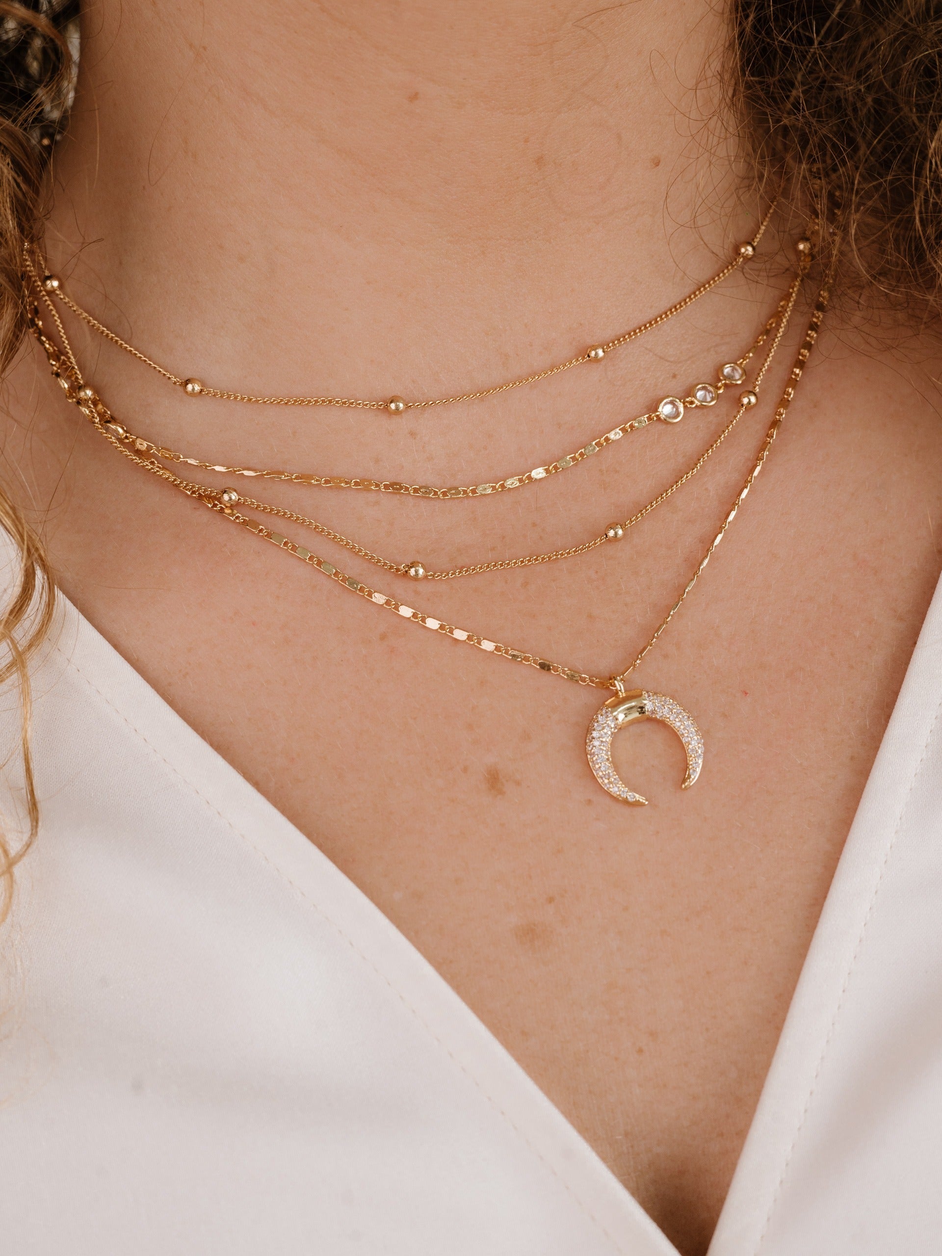 Layered Gold Chain & Crescent Horn Necklace on model 2