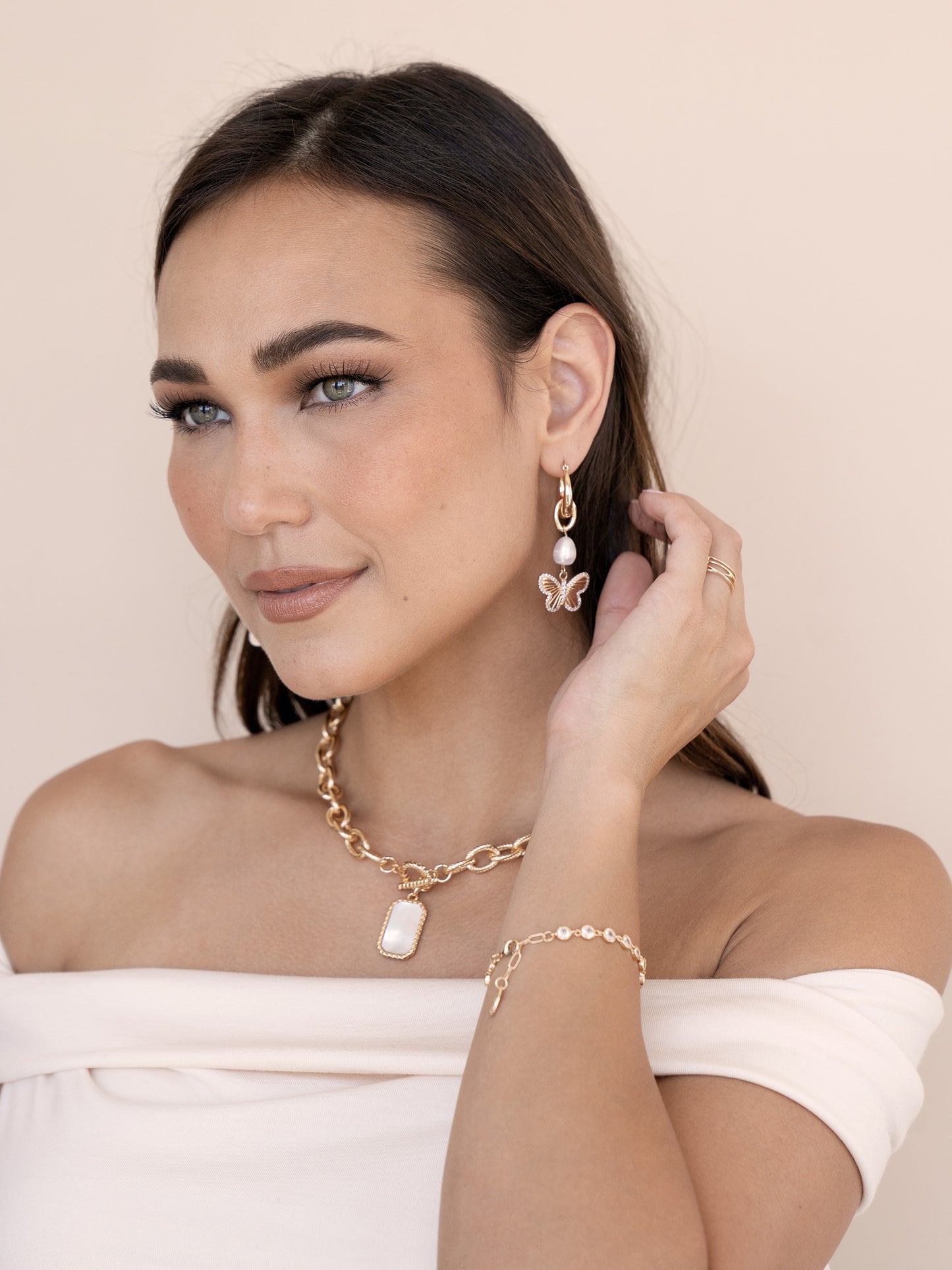 Butterfly High Pearl Drop Earrings on model 3