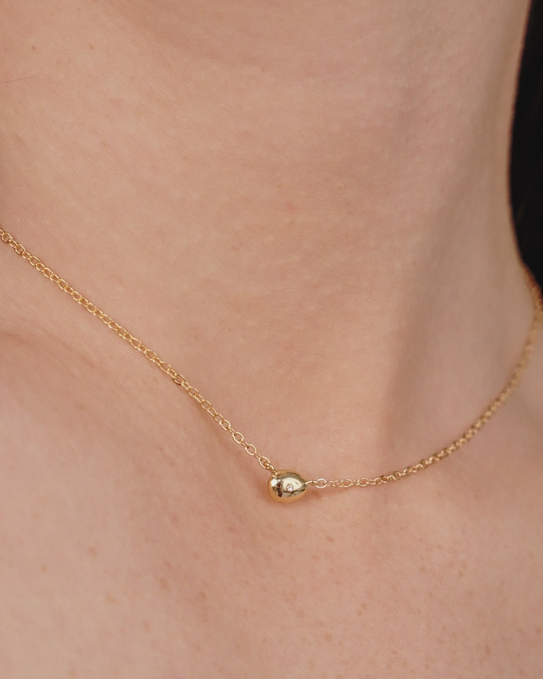 Polished Dainty Pebble Pendant Necklace on model in video