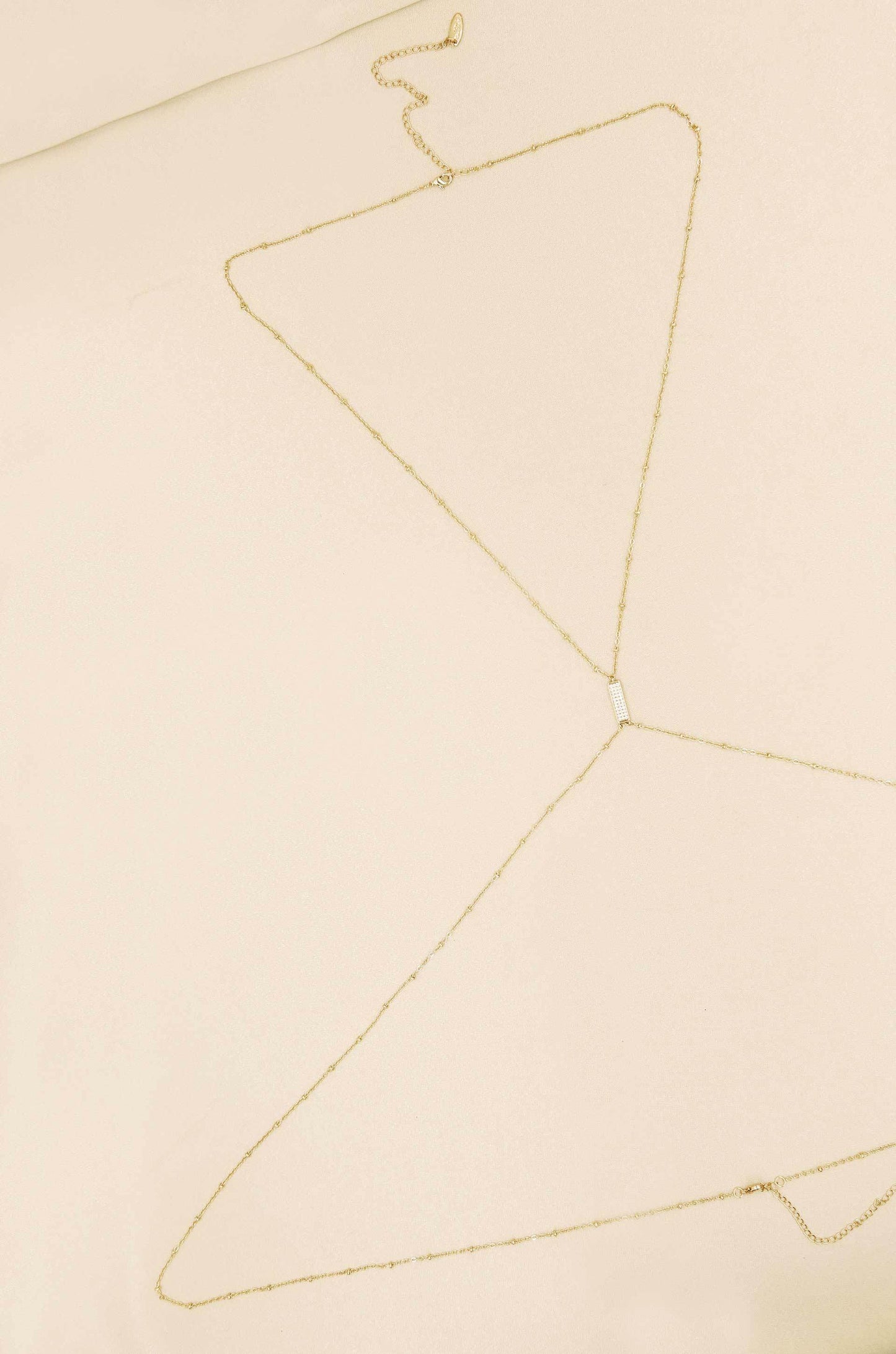 Sun Searcher Body Chain in Gold on slate background