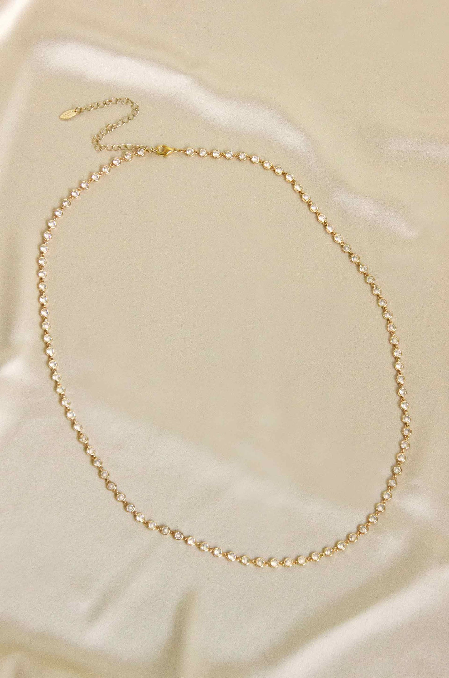 Always A Pleasure Dainty Crystal Body Chain on slate background
