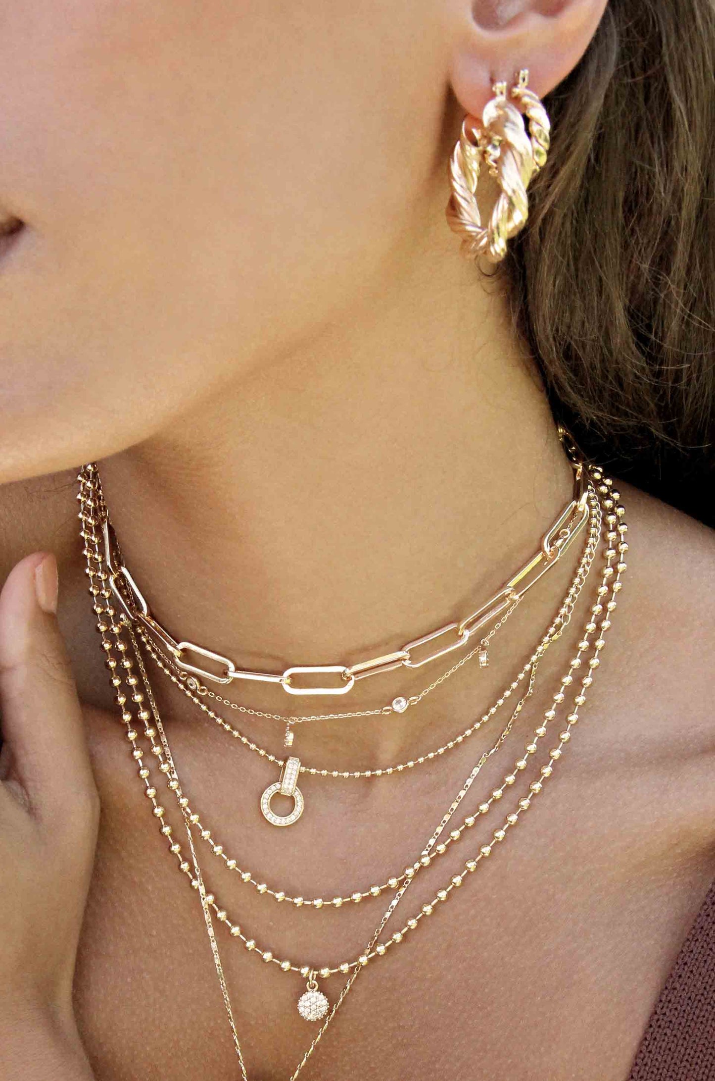 Modern Day 18k Gold Plated Twist Hoops shown on a model