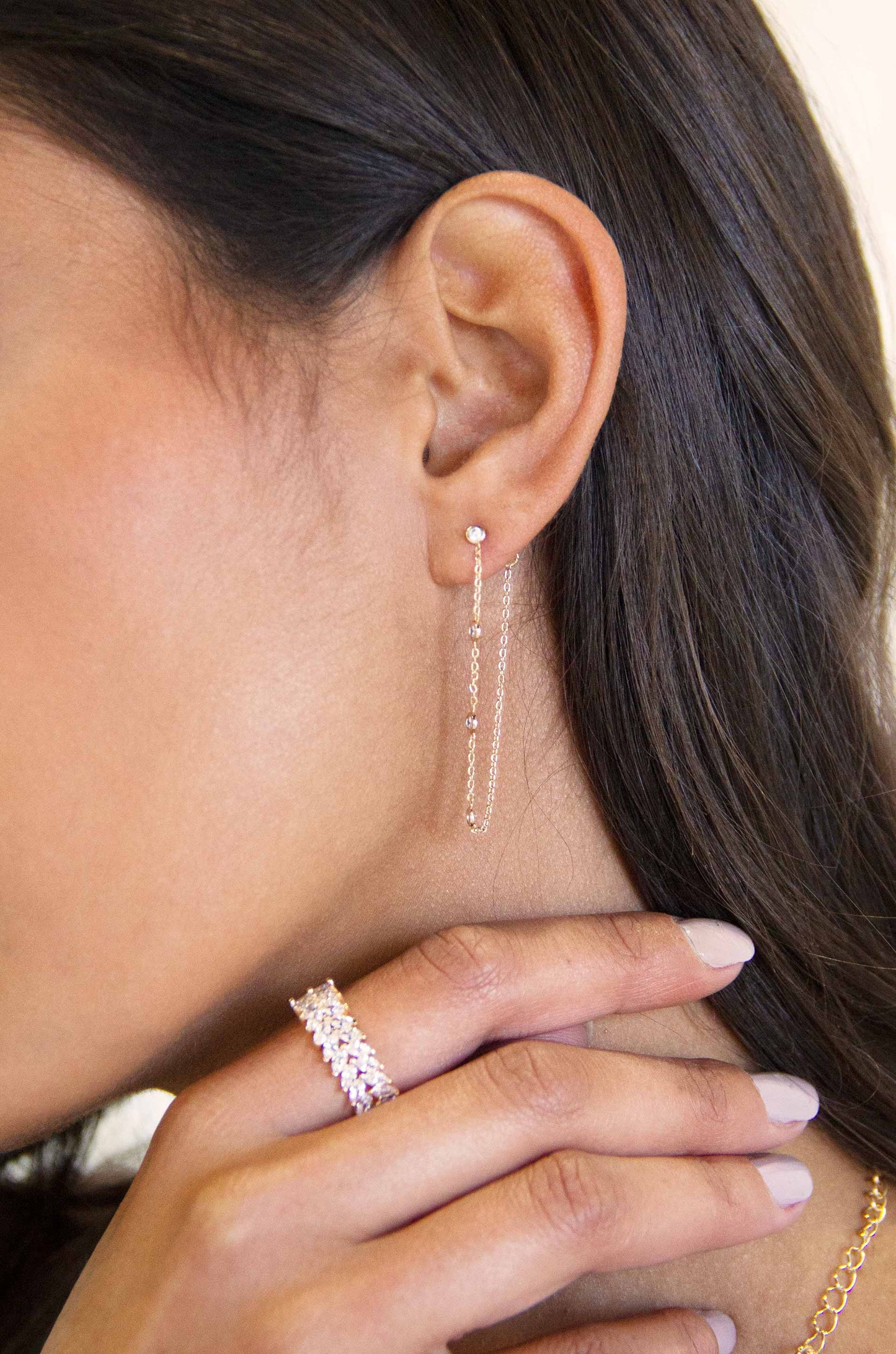 Elegantly Modern Chain and Crystal Strand 18k Gold Plated Earrings on a model