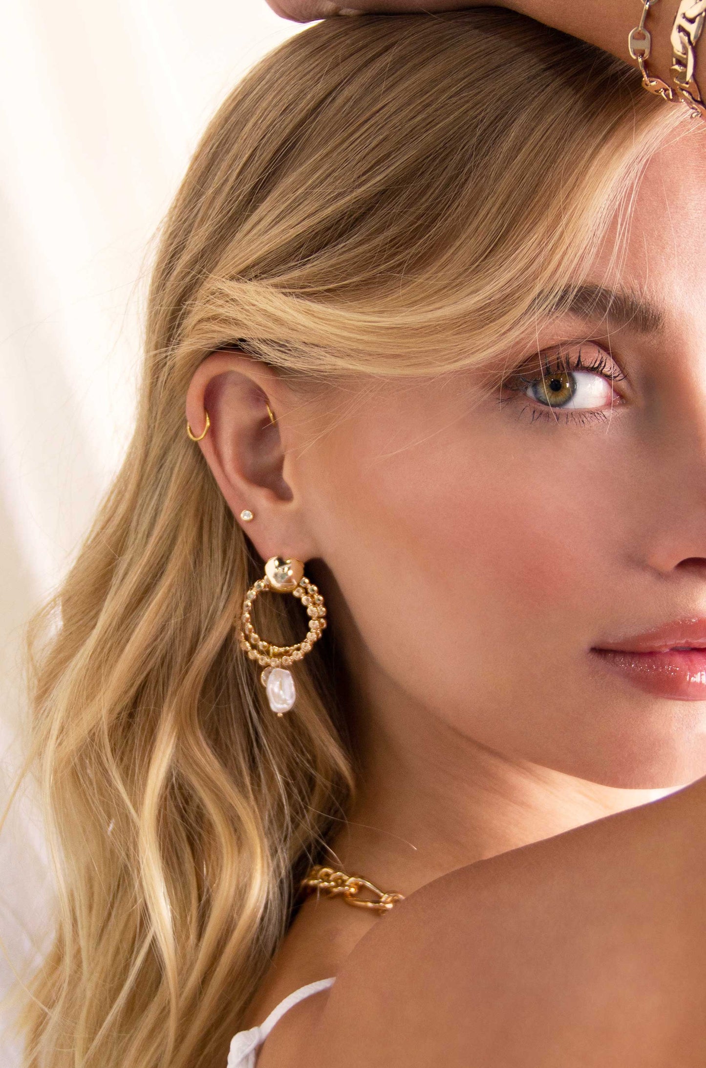 Pearl and Crystal Hanging Charm 18k Gold Plated Earrings on a model
