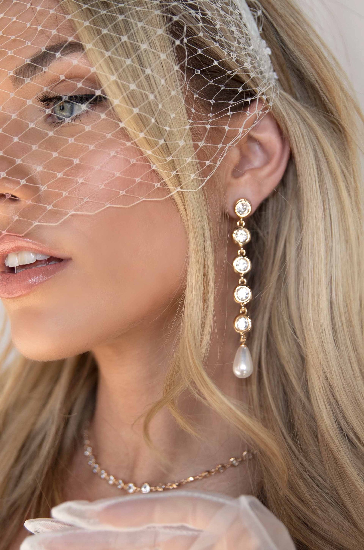 Elegantly Modern Crystal and Pearl 18k Gold Plated Dangle Earrings on a model