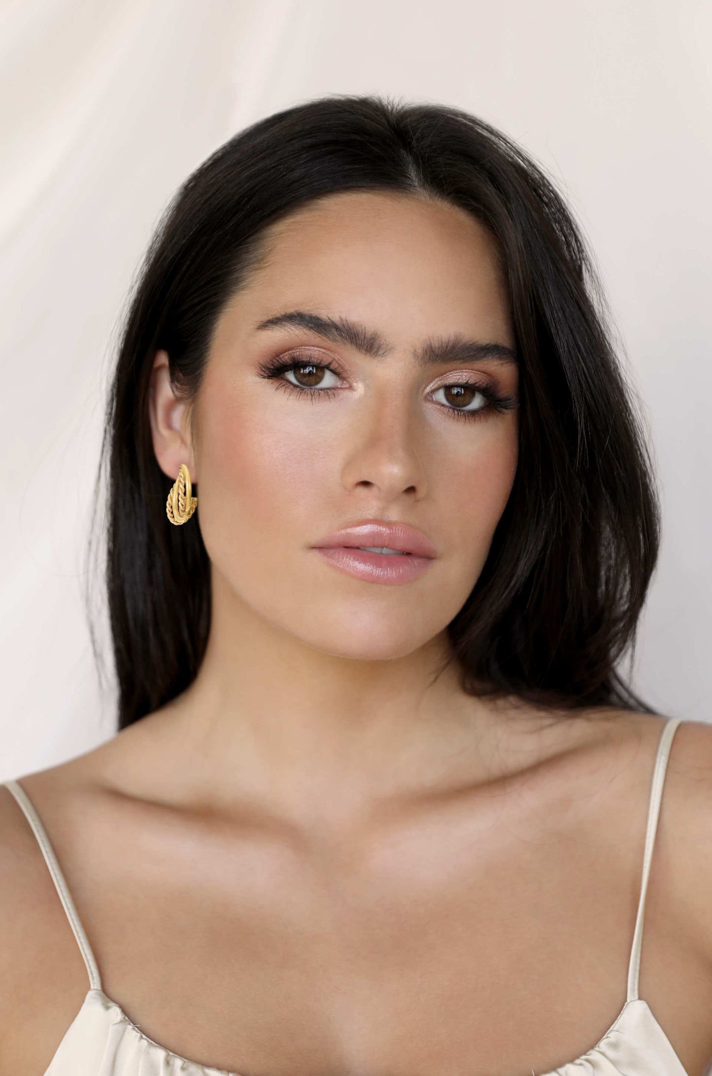Twists and Turns 18k Gold Plated Hoop Earrings on model