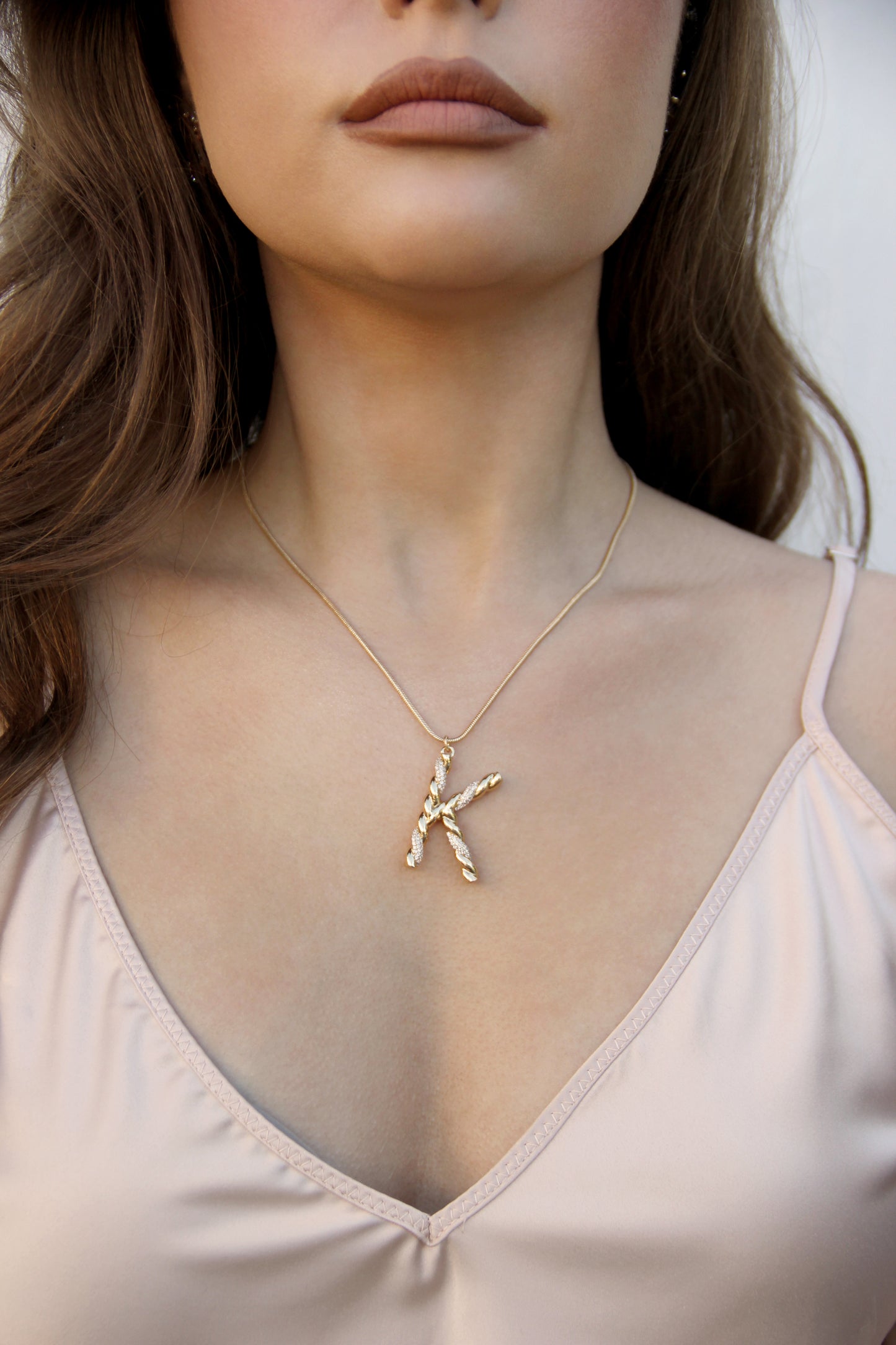 Letter K Twisted Crystal Initial 18k Gold Plated Necklace shown on a model