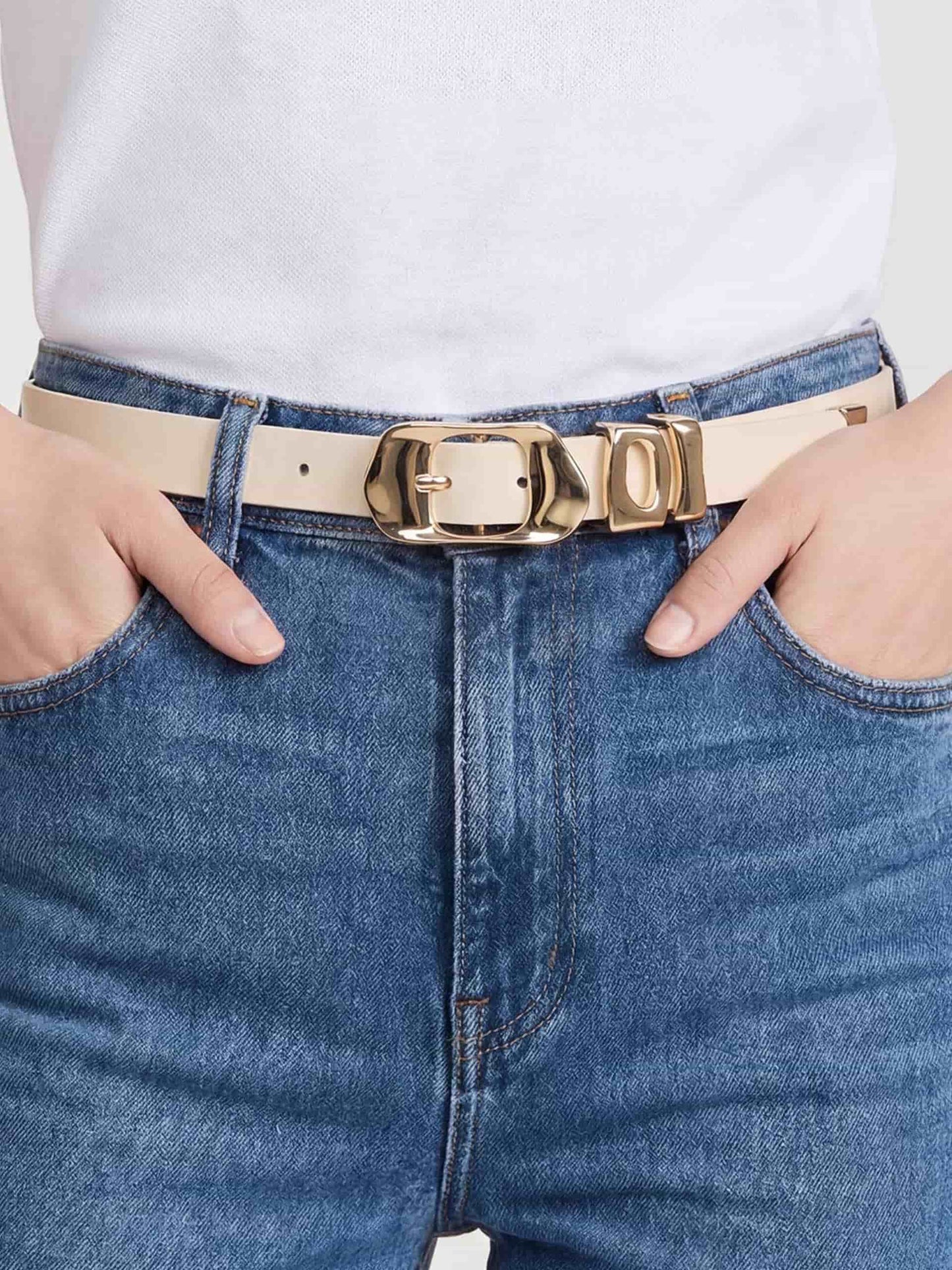 Vanilla belt with gold buckle styled with denim jeans.