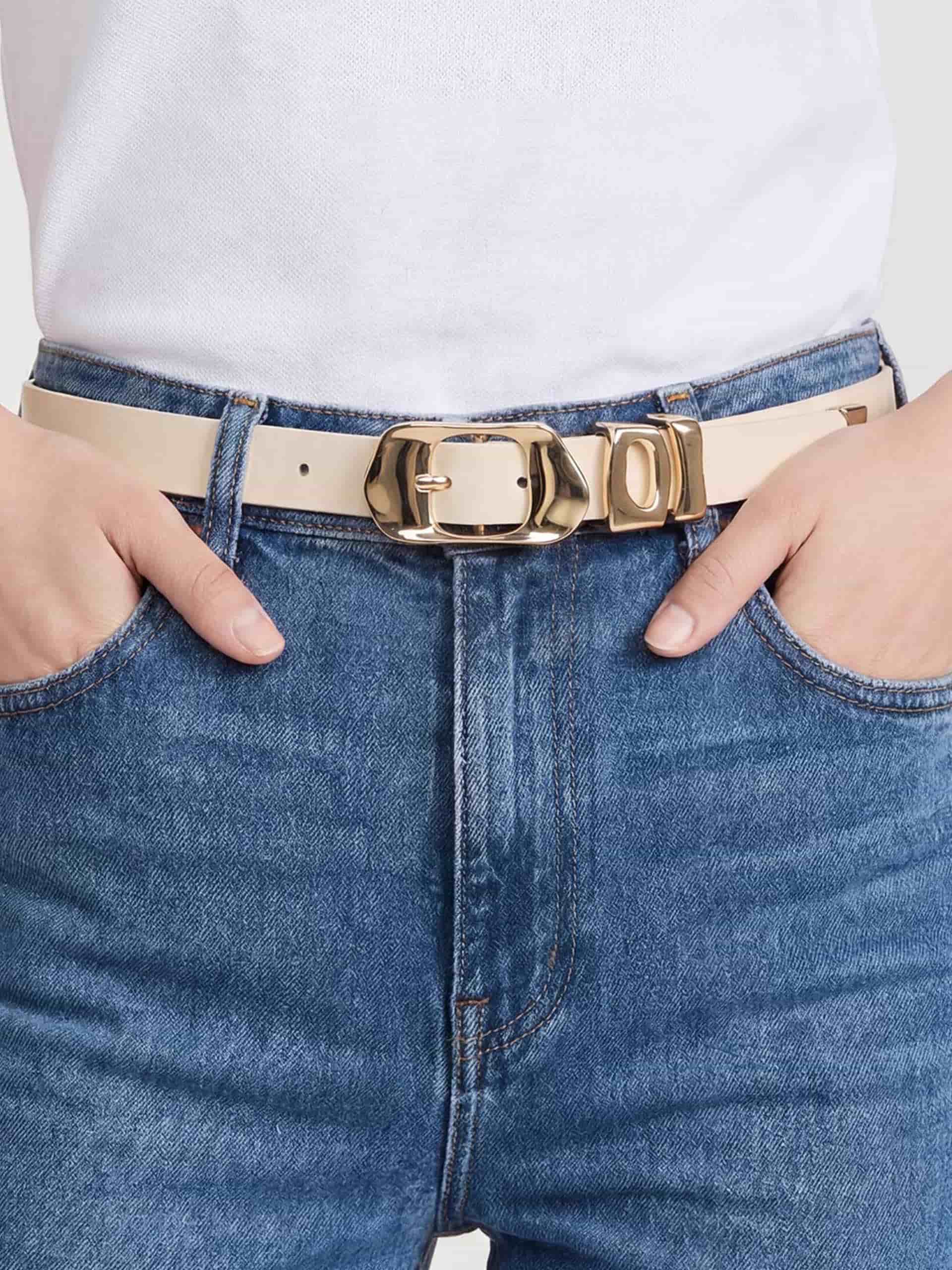 Vanilla belt with gold buckle styled with denim jeans.