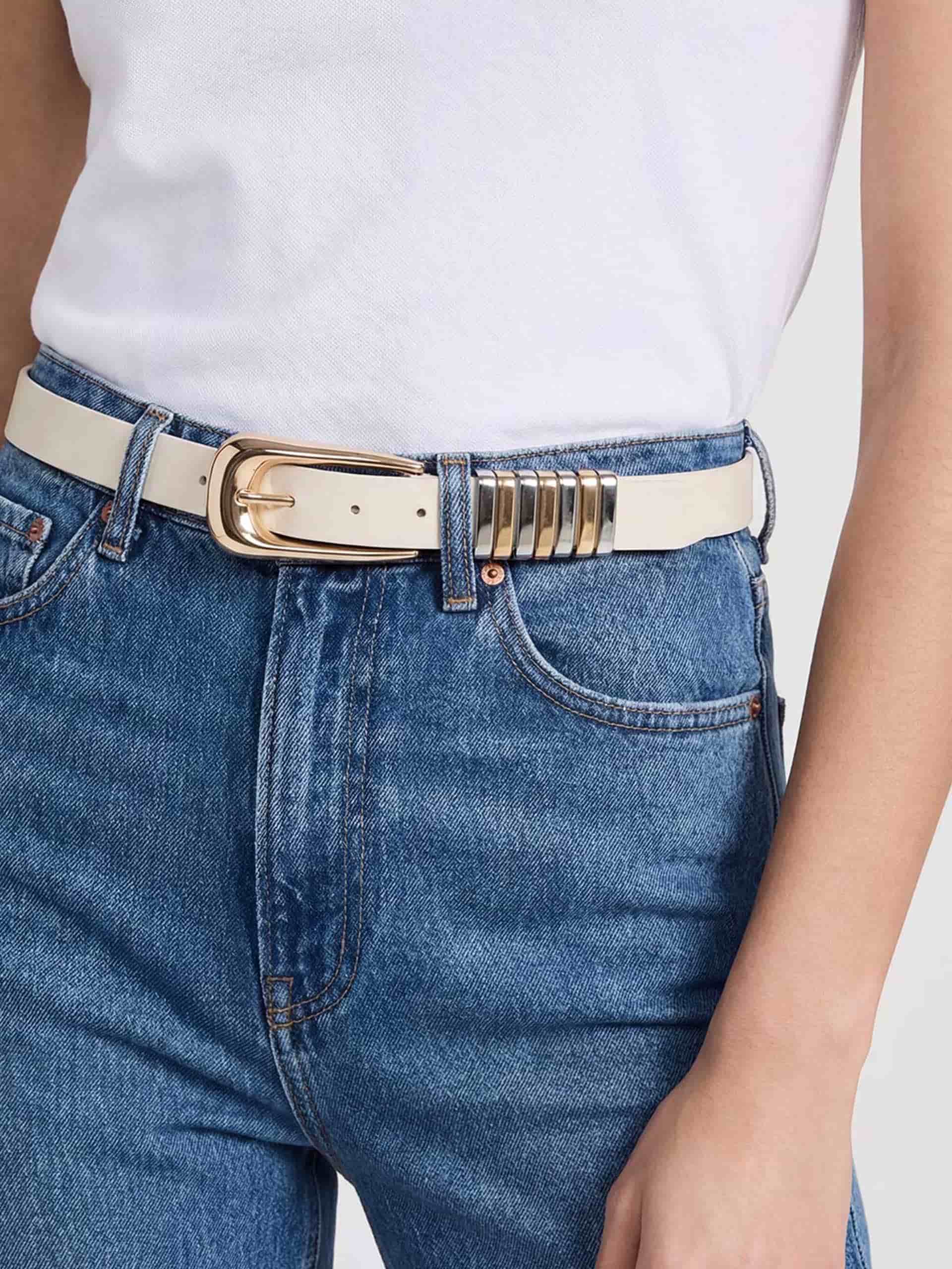 Vanilla leather belt with gold buckle on denim jeans.