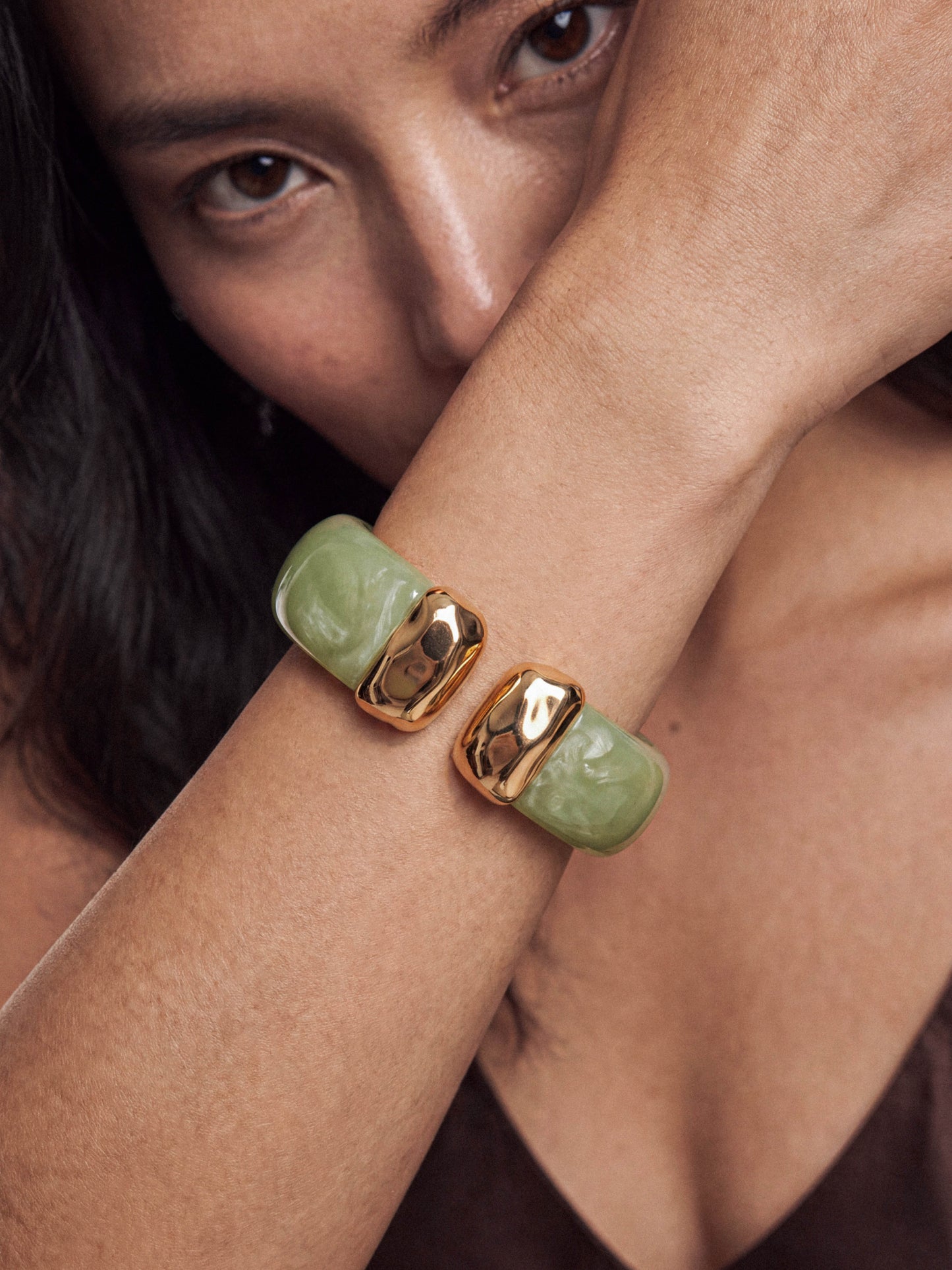 Close view of green stone cuff on wrist