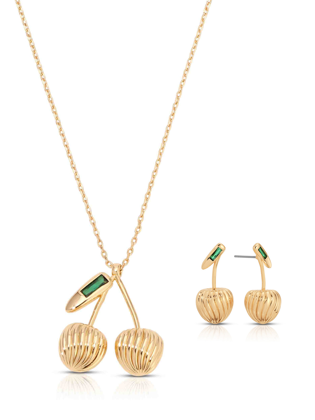 Gold cherry-inspired jewelry set: a long necklace with a sculpted, ribbed twin-fruit pendant and matching drop earrings, each with green accents; elegant, playful tone.