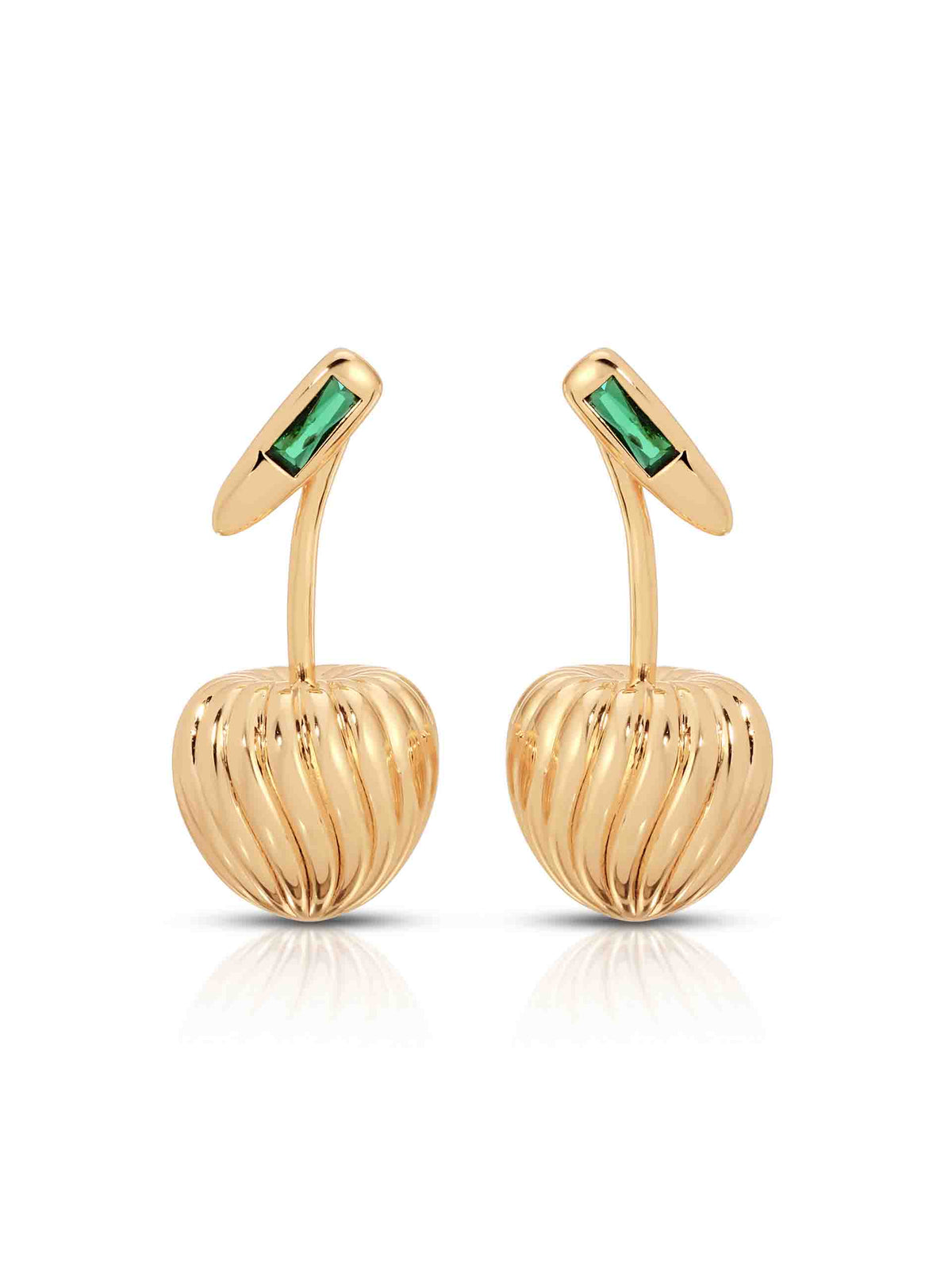 Pair of gold cherry-shaped drop earrings with ribbed, sculptural bodies and rectangular emerald-green gemstone studs, displayed on white; elegant, playful luxury jewelry.