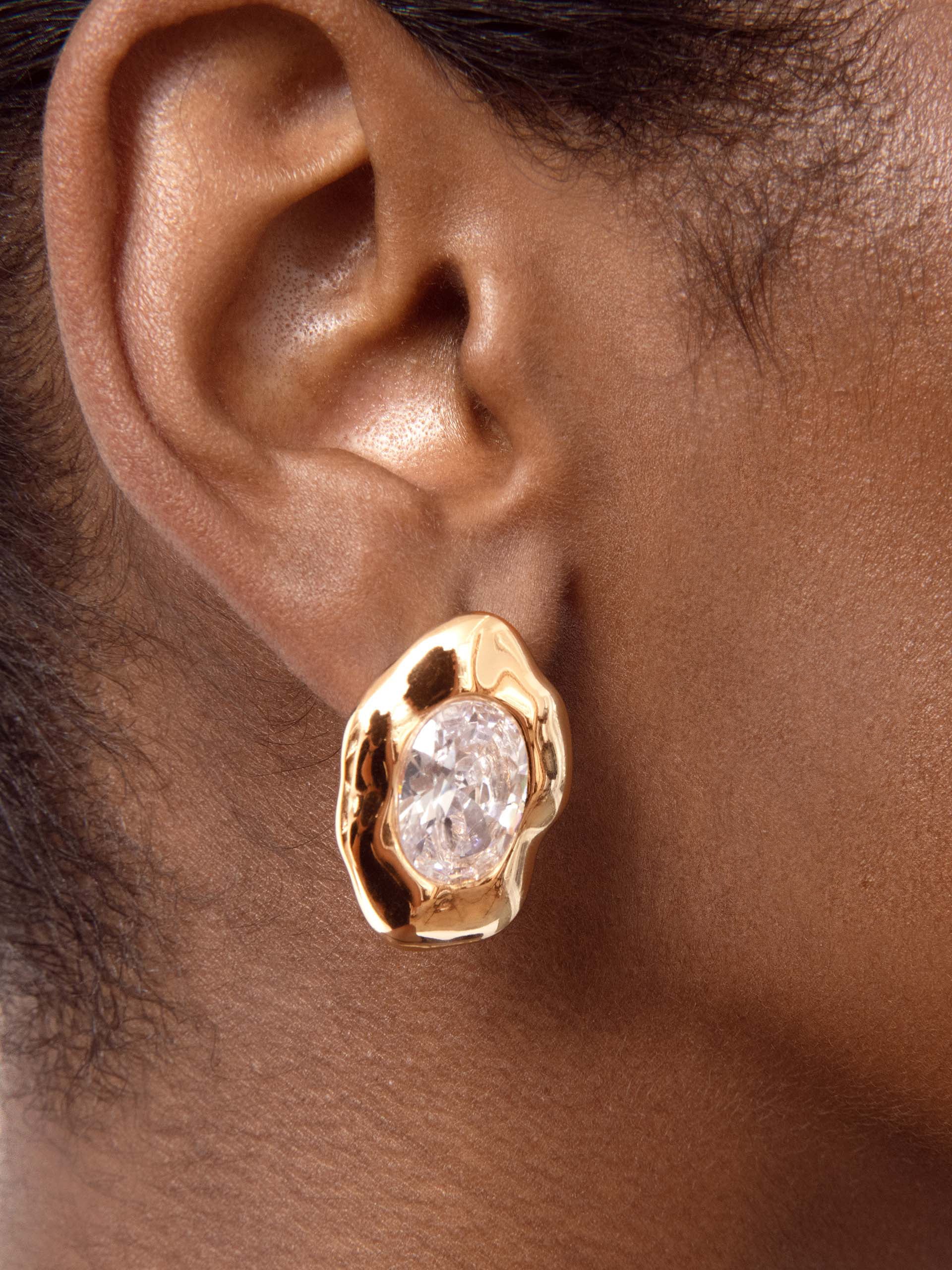 Molten Glow Crystal Studs Clear Crystal with 18k Gold Plating on model