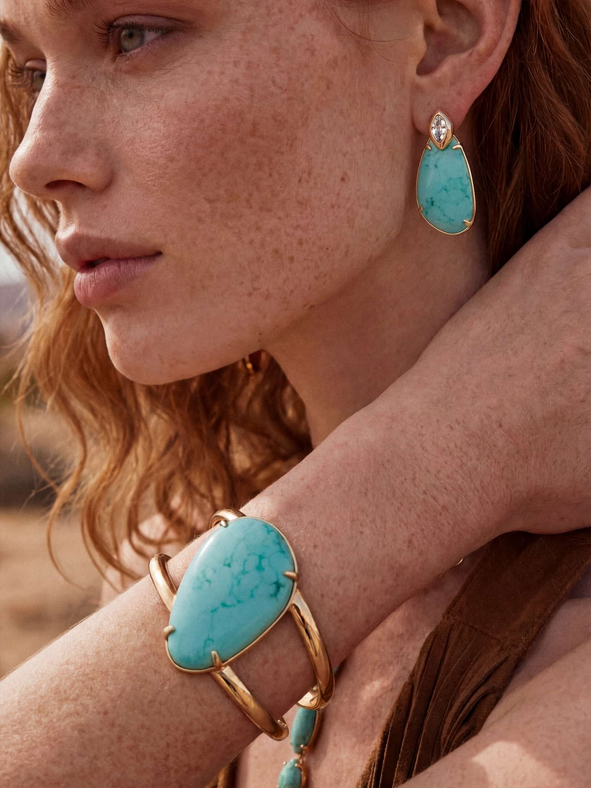 Model wearing turquoise bracelet and matching cuff