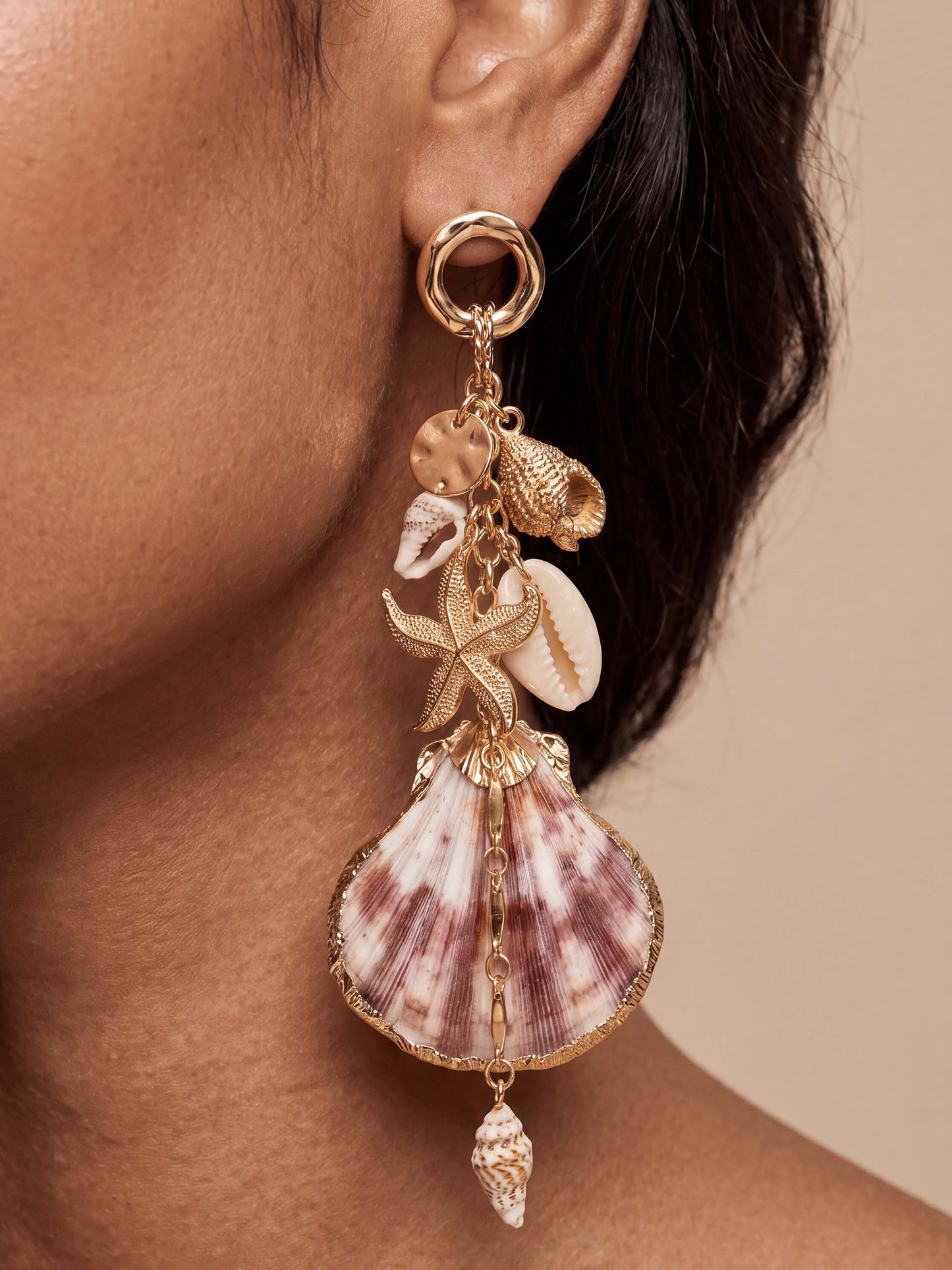 Woman wears Mermaid Tears seashell earrings