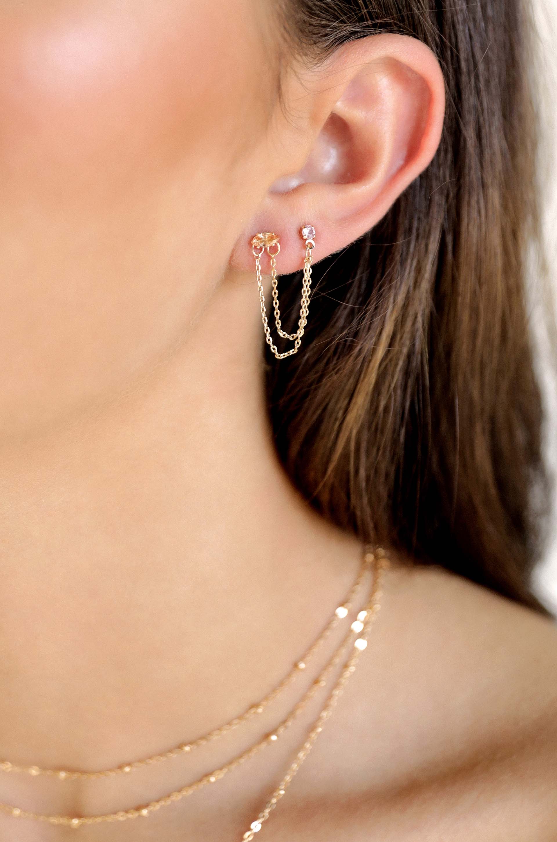 Double Piercing Chain Dangle Earrings in pink and light topaz on model