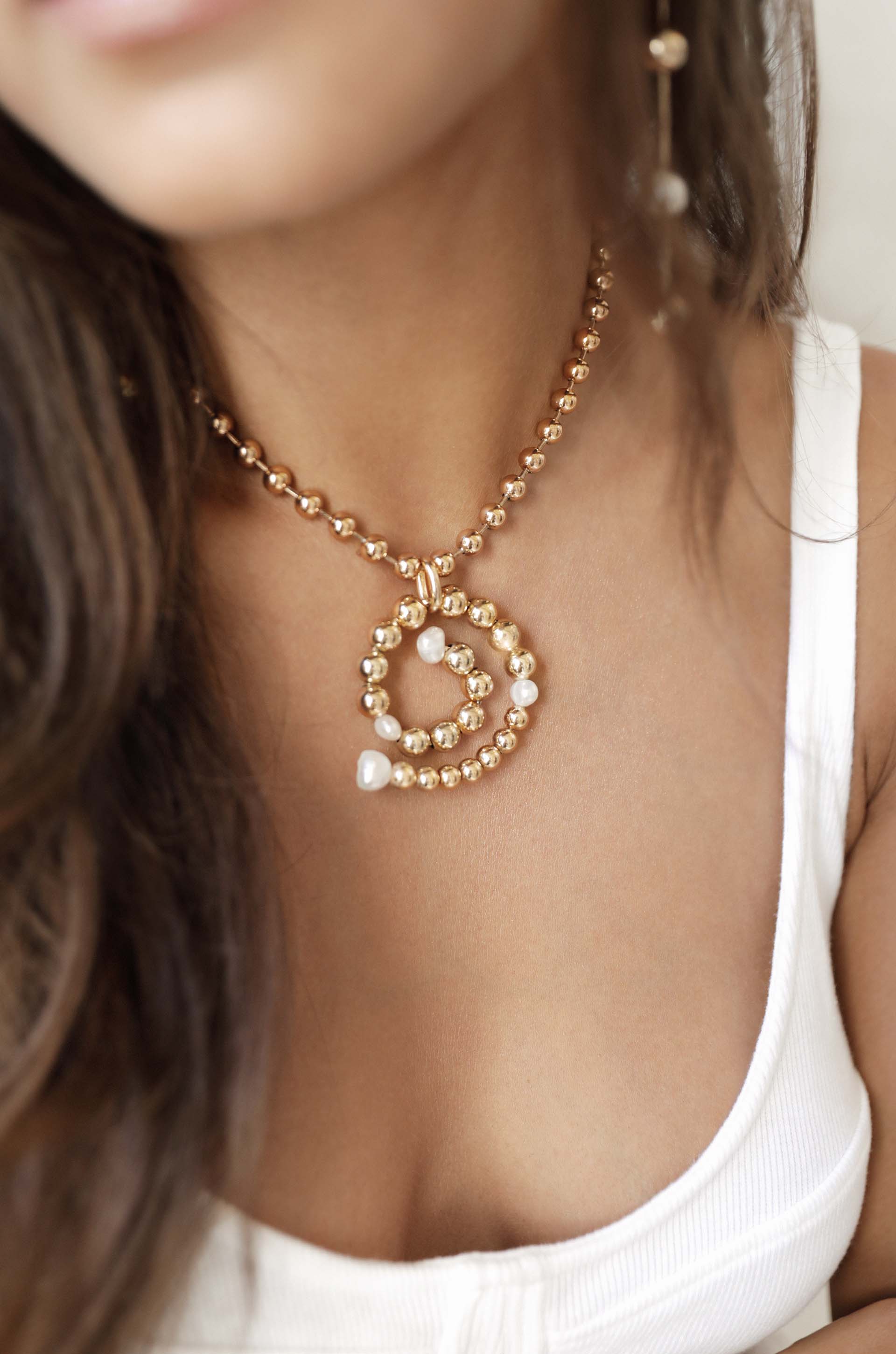 Golden Pearl Swirl Necklace on model