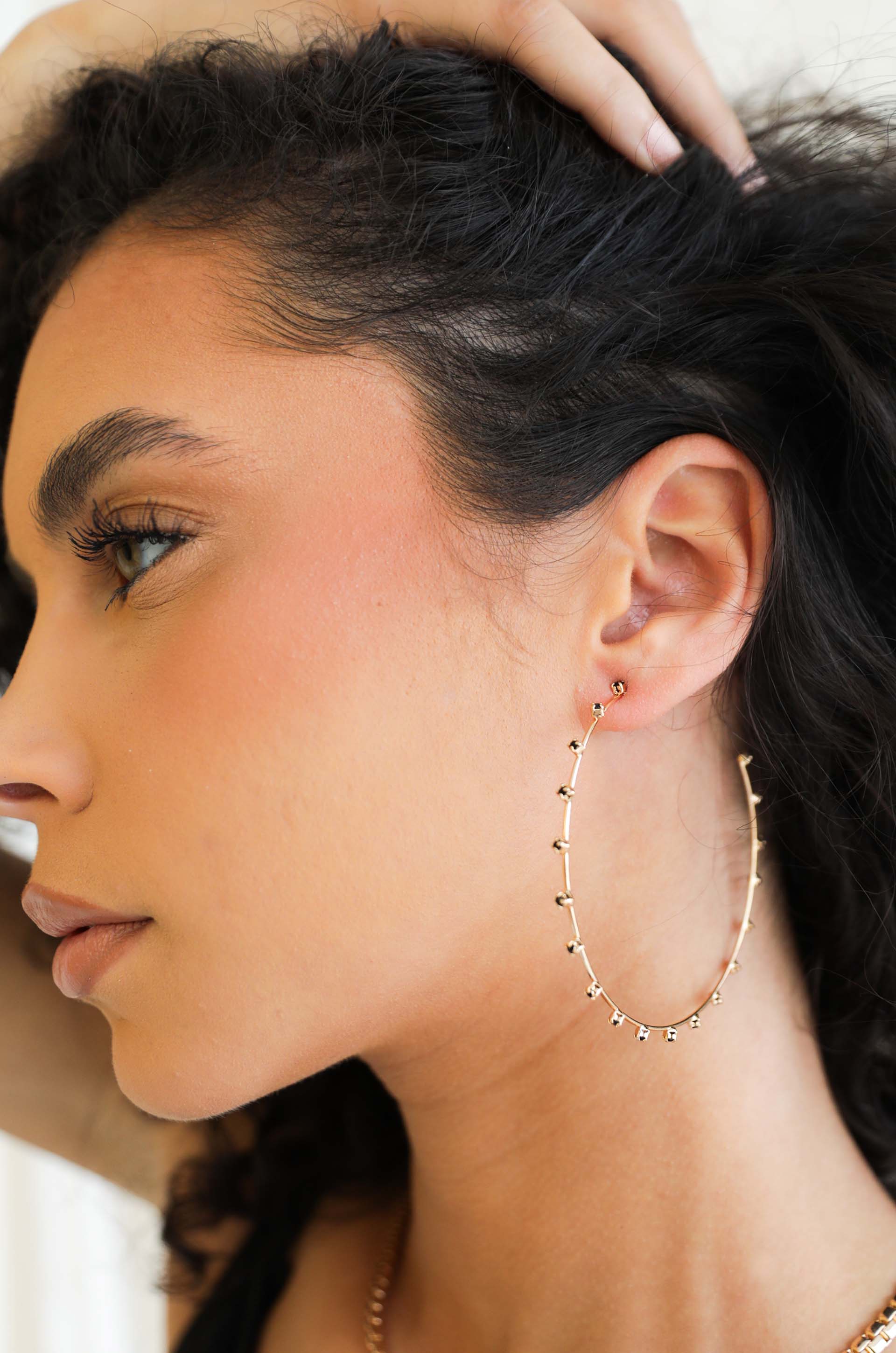 Simple Spark Crystal Hoops in black on model