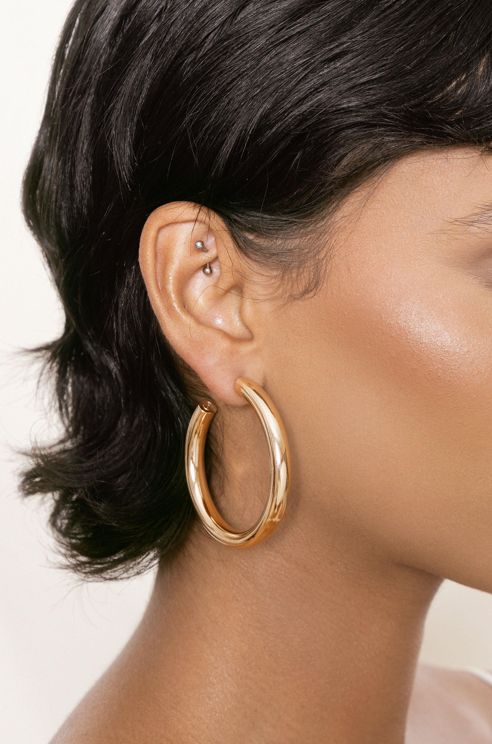 Thick Classic Hoops in large in gold on model