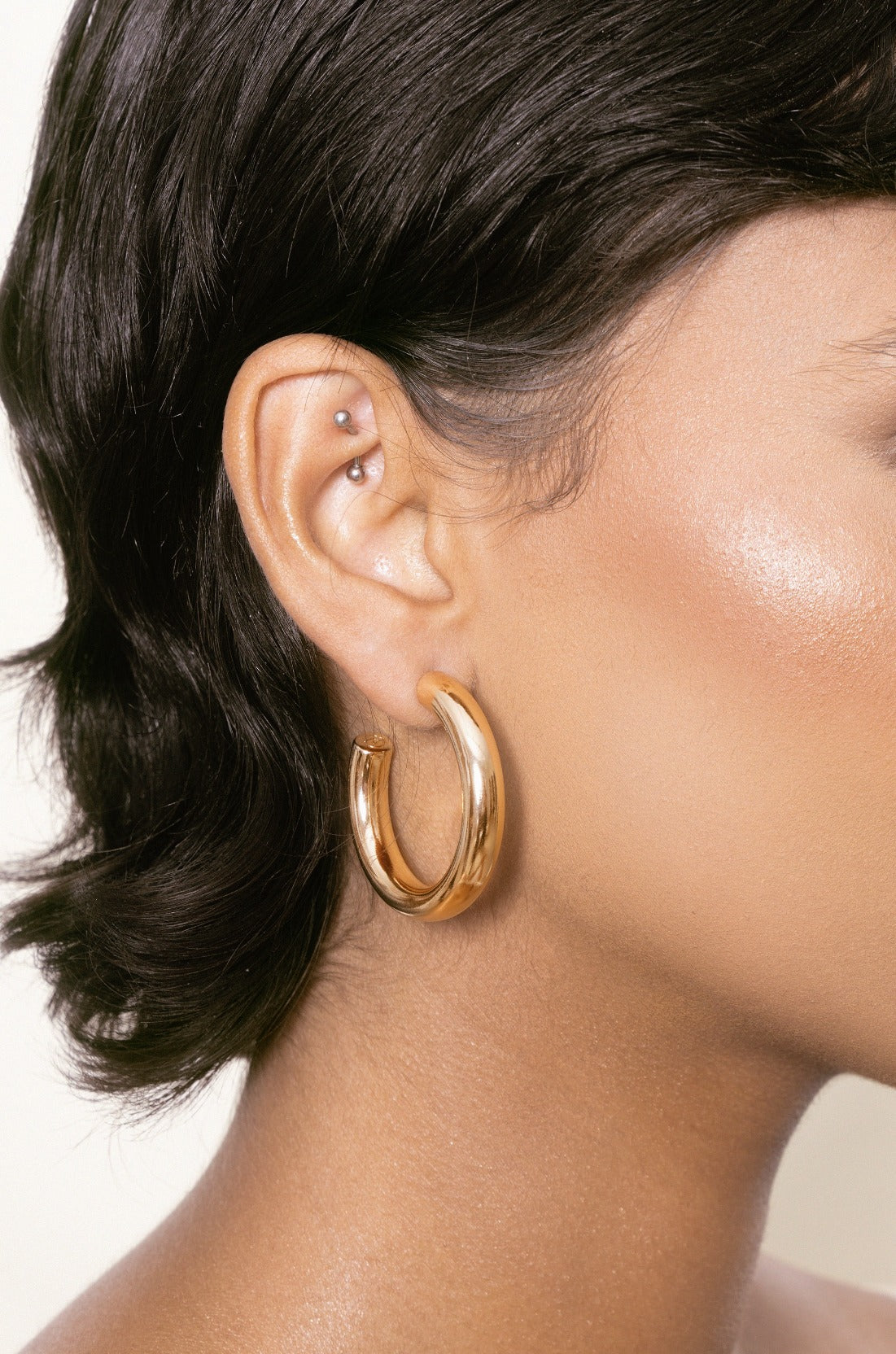 Thick Classic Hoops in medium in gold on model