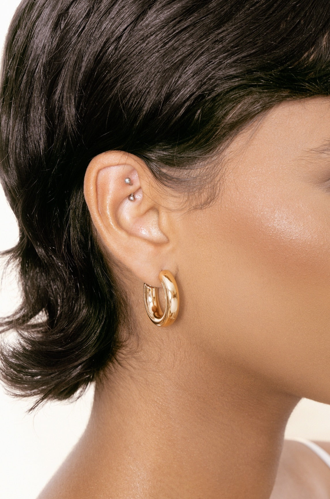 Thick Classic Hoops in small in gold on model