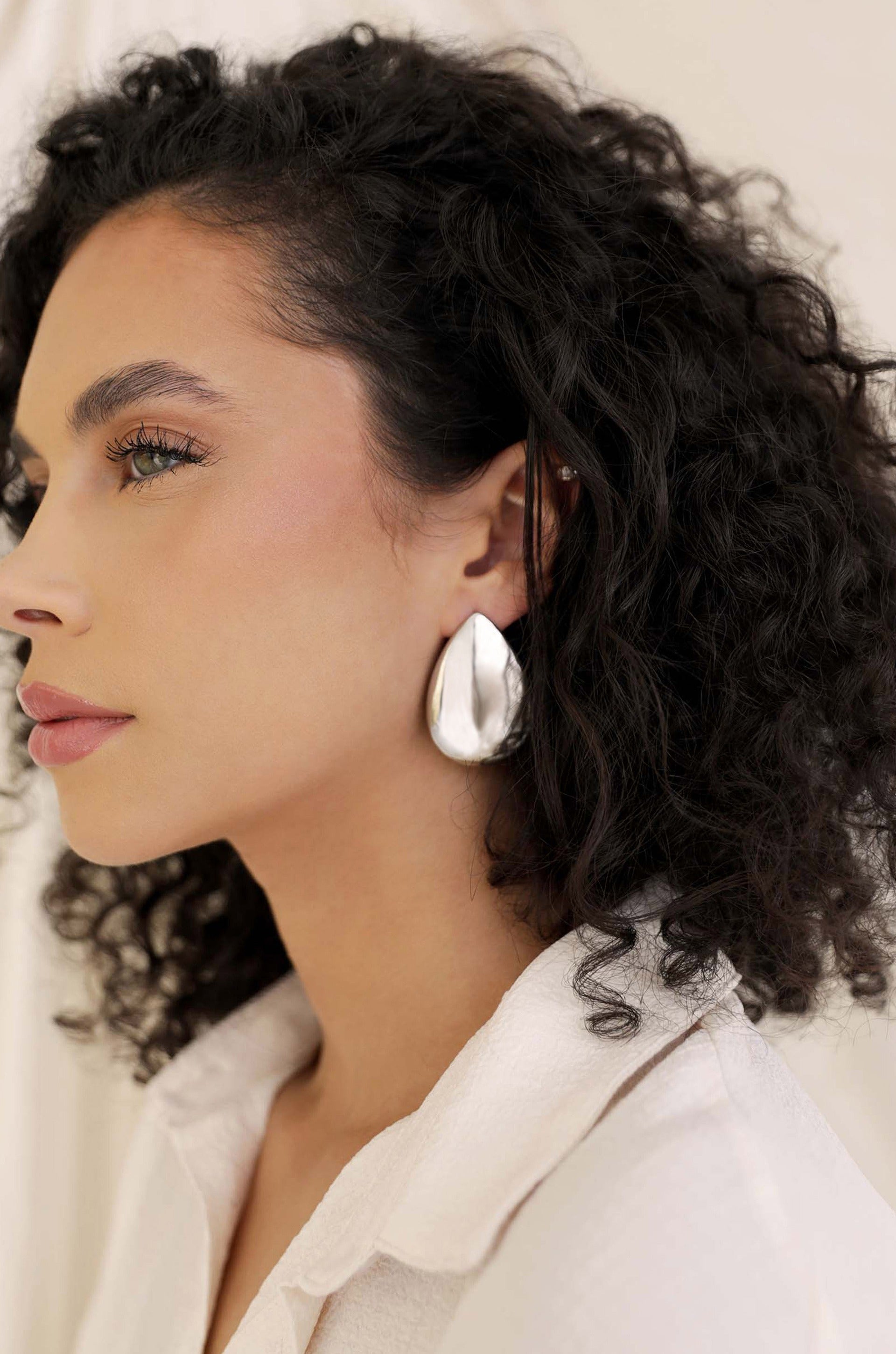 Statement Tear Drop Earrings in rhodium on model