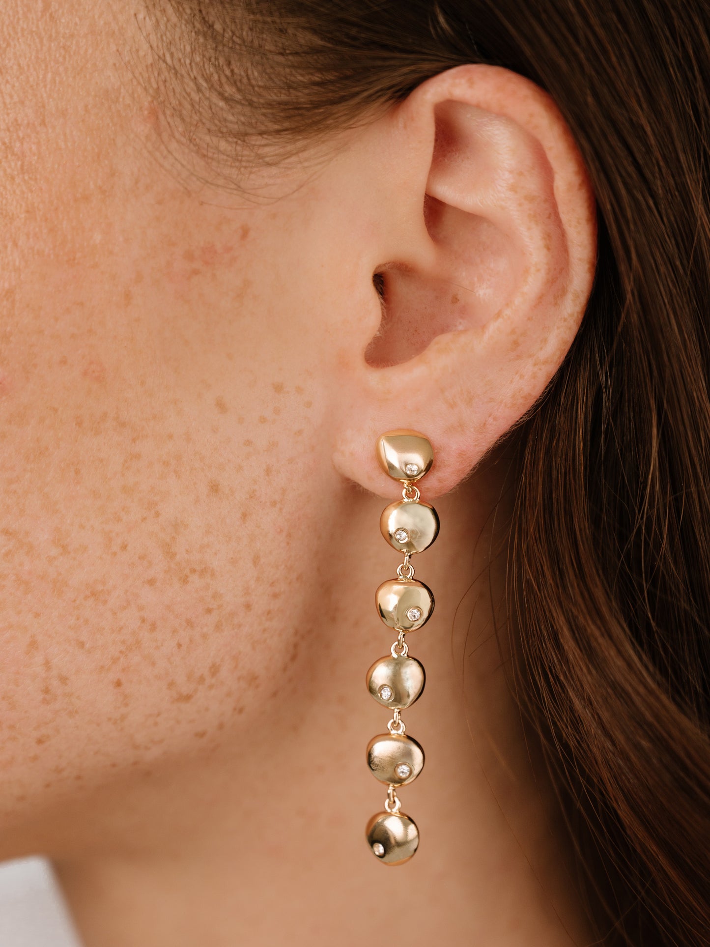 Polished Pebble Linear Dangle Earrings on model 5