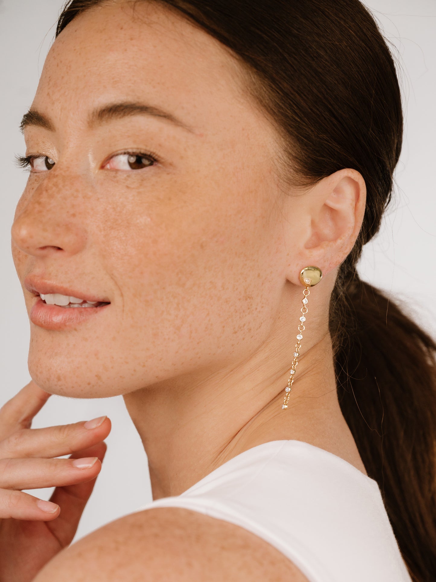 Polished Pebble Linear Crystal Chain Drop Earrings on model 4