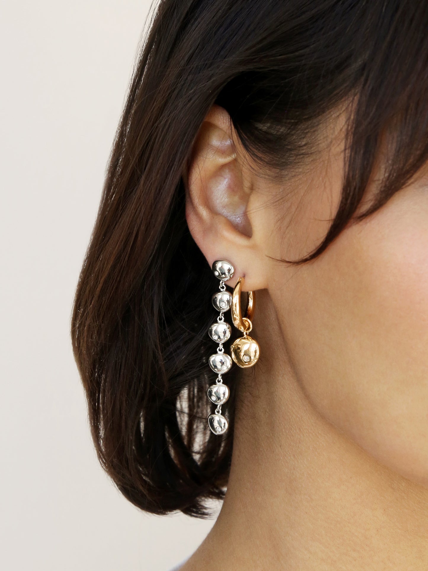 Polished Pebble Linear Dangle Earrings on model 2
