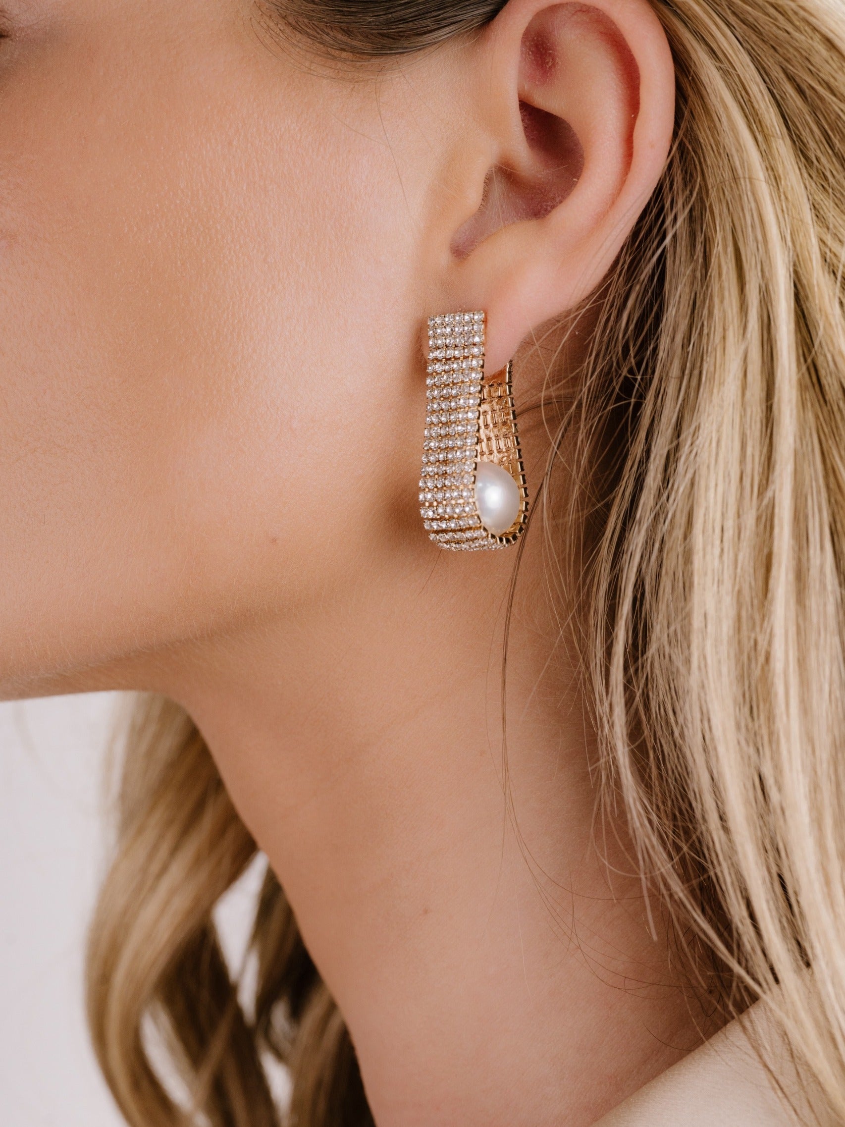 Swaddled Pearl Crystal Teardrop Earrings on model 