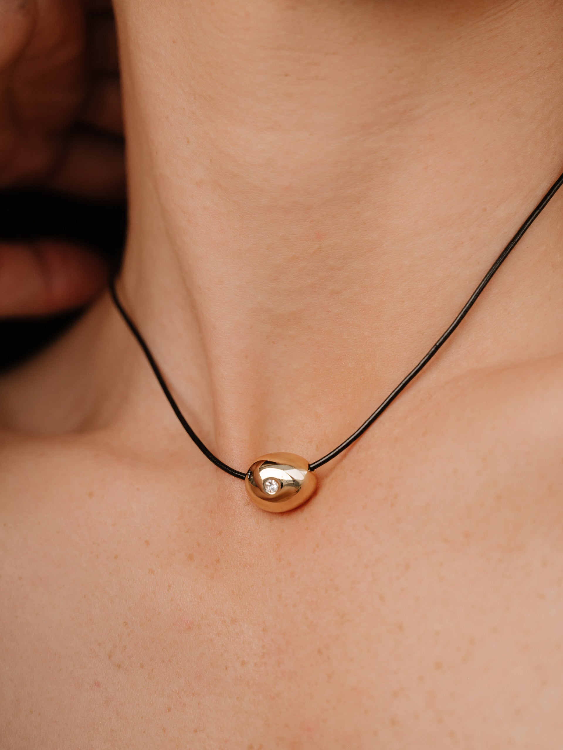 Single Crystal Polished Pebble Leather Pendant Necklace on model 
