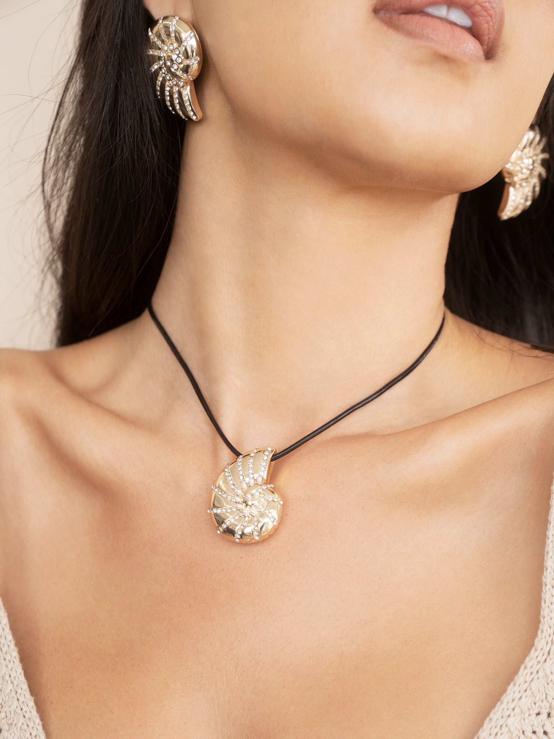 Crystal Studded Nautilus Shell Earrings on model 2