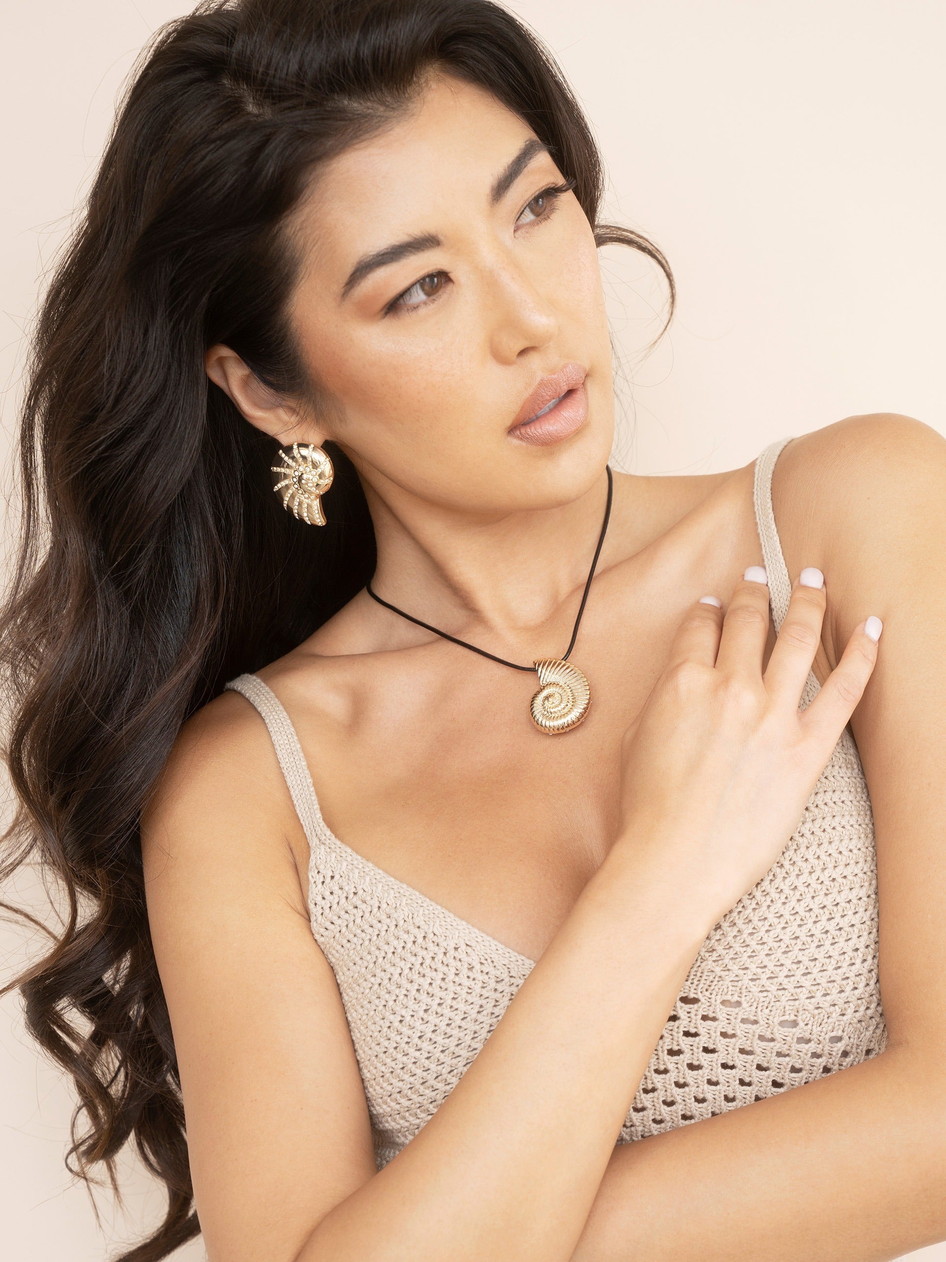 Crystal Studded Nautilus Shell Earrings on model 4