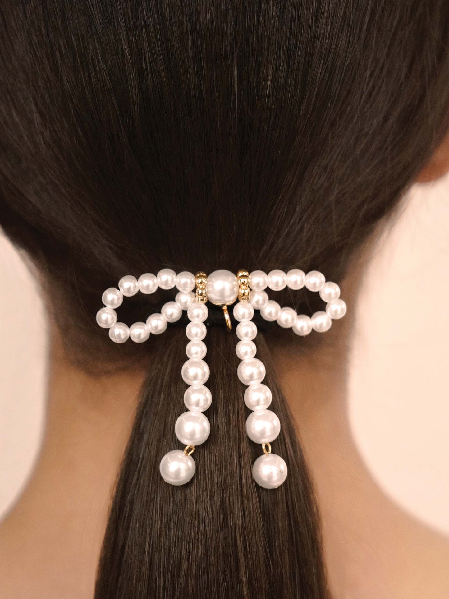 Aurora Pearl Bow Hair Tie Gold Tone with Black Elastic model