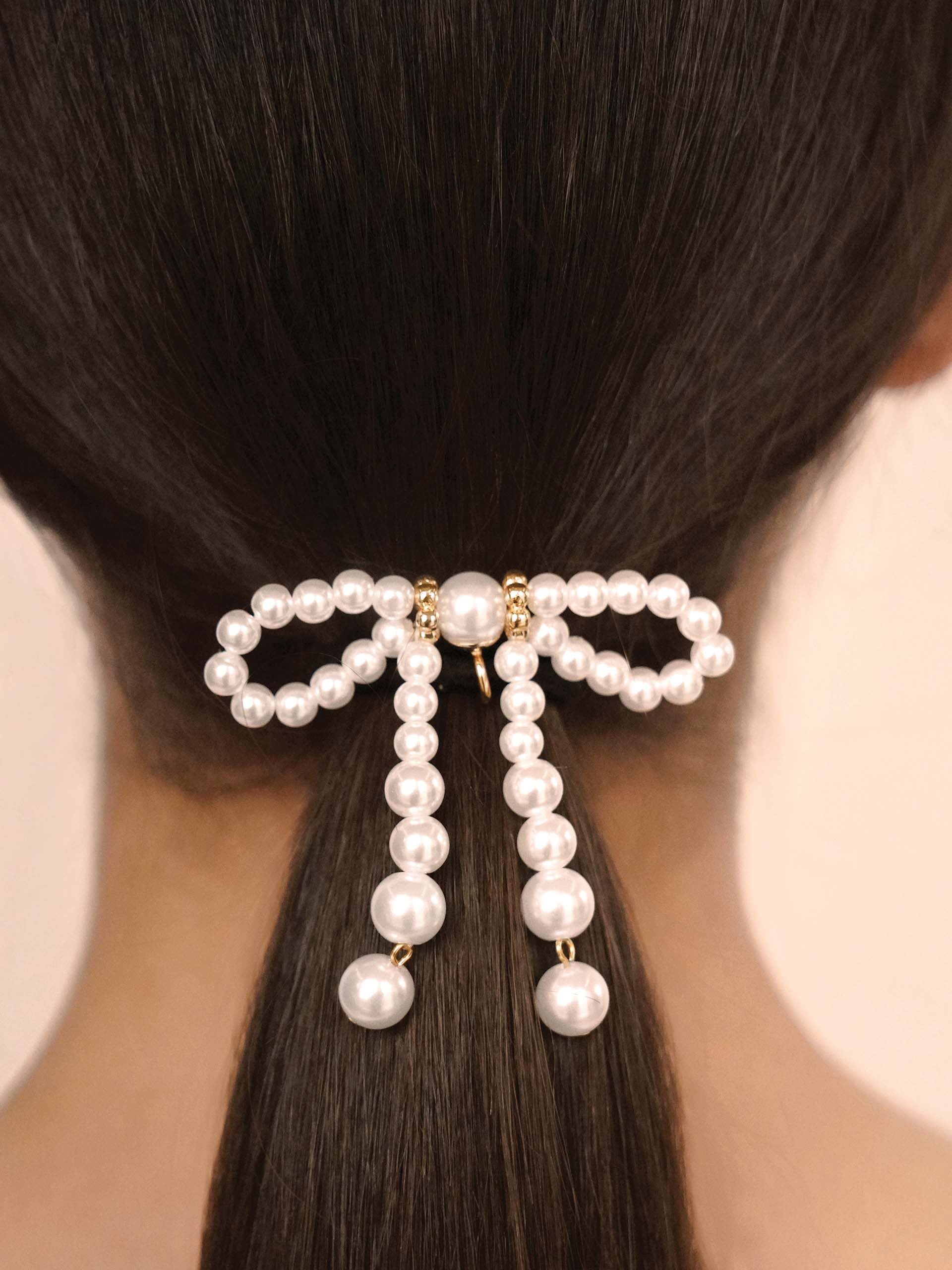 Aurora Pearl Bow Hair Tie Gold Tone with Black Elastic model
