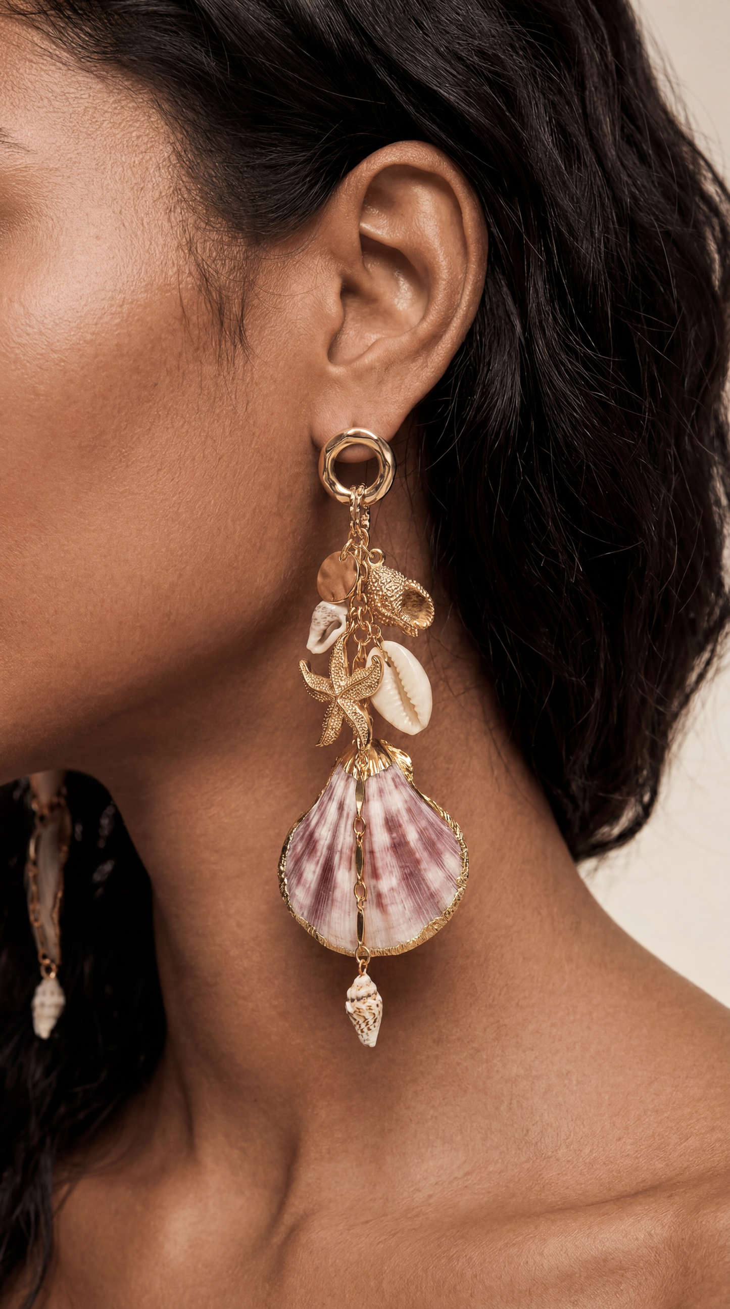 Woman wears Mermaid Tears seashell earrings