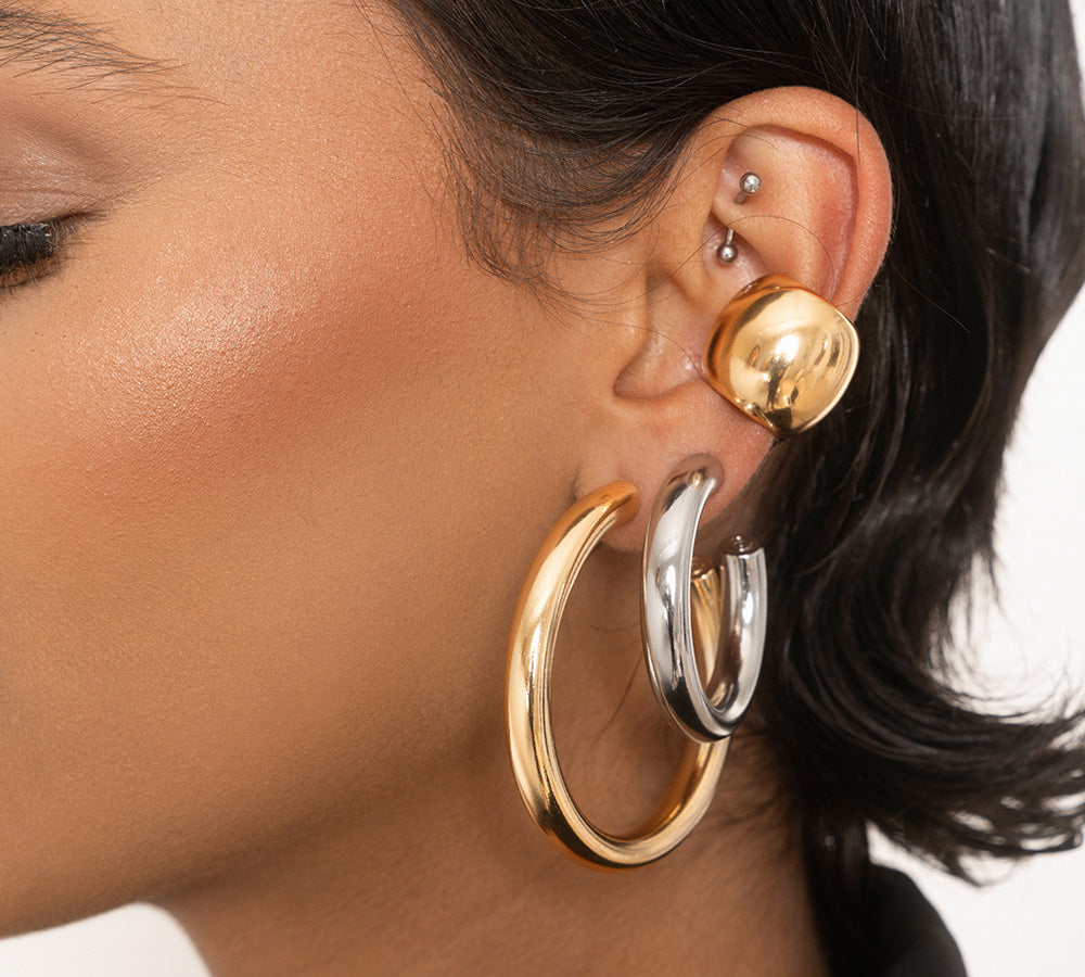model in stacked mixed metal earrings