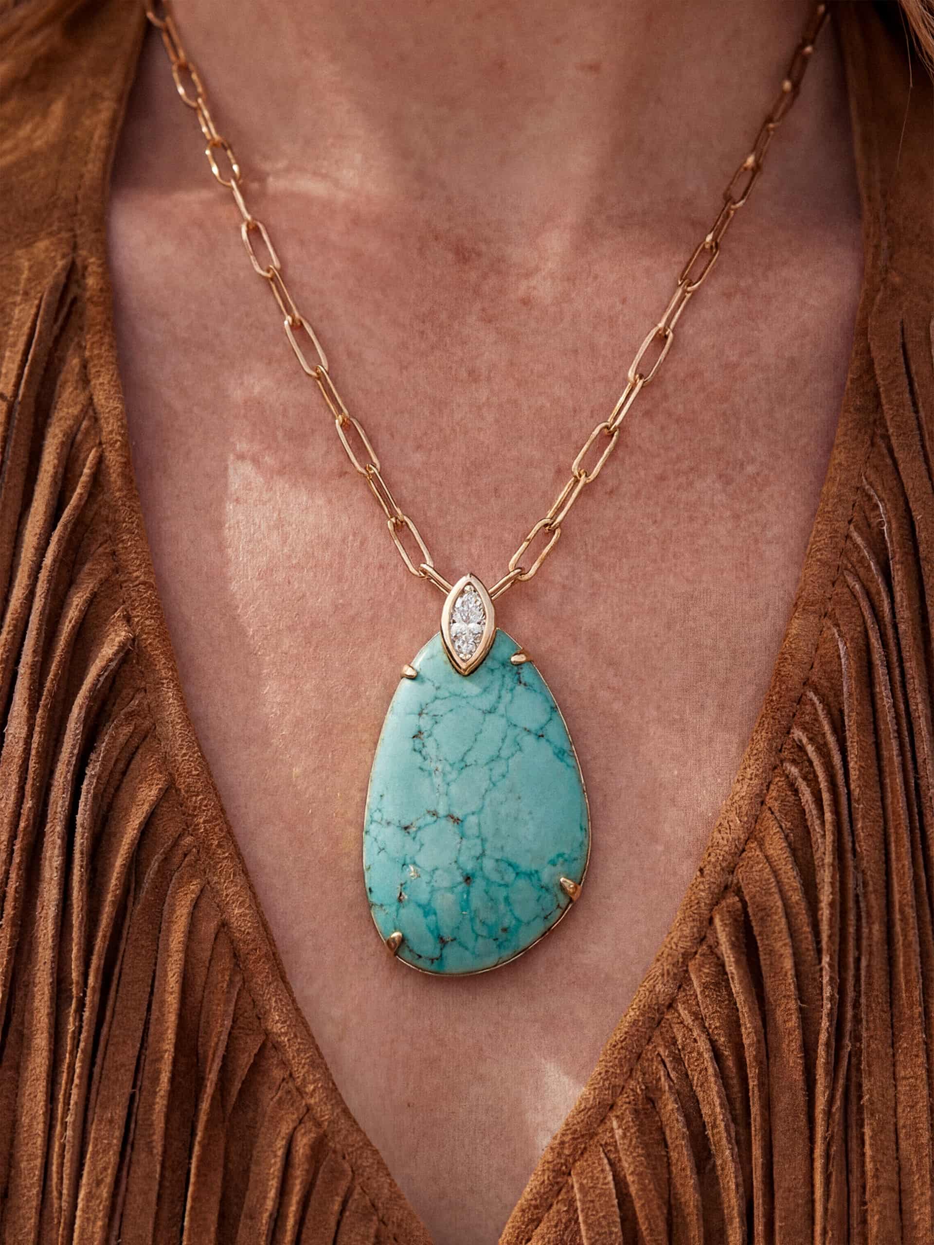 Turquoise pendant necklace on brown fringed top