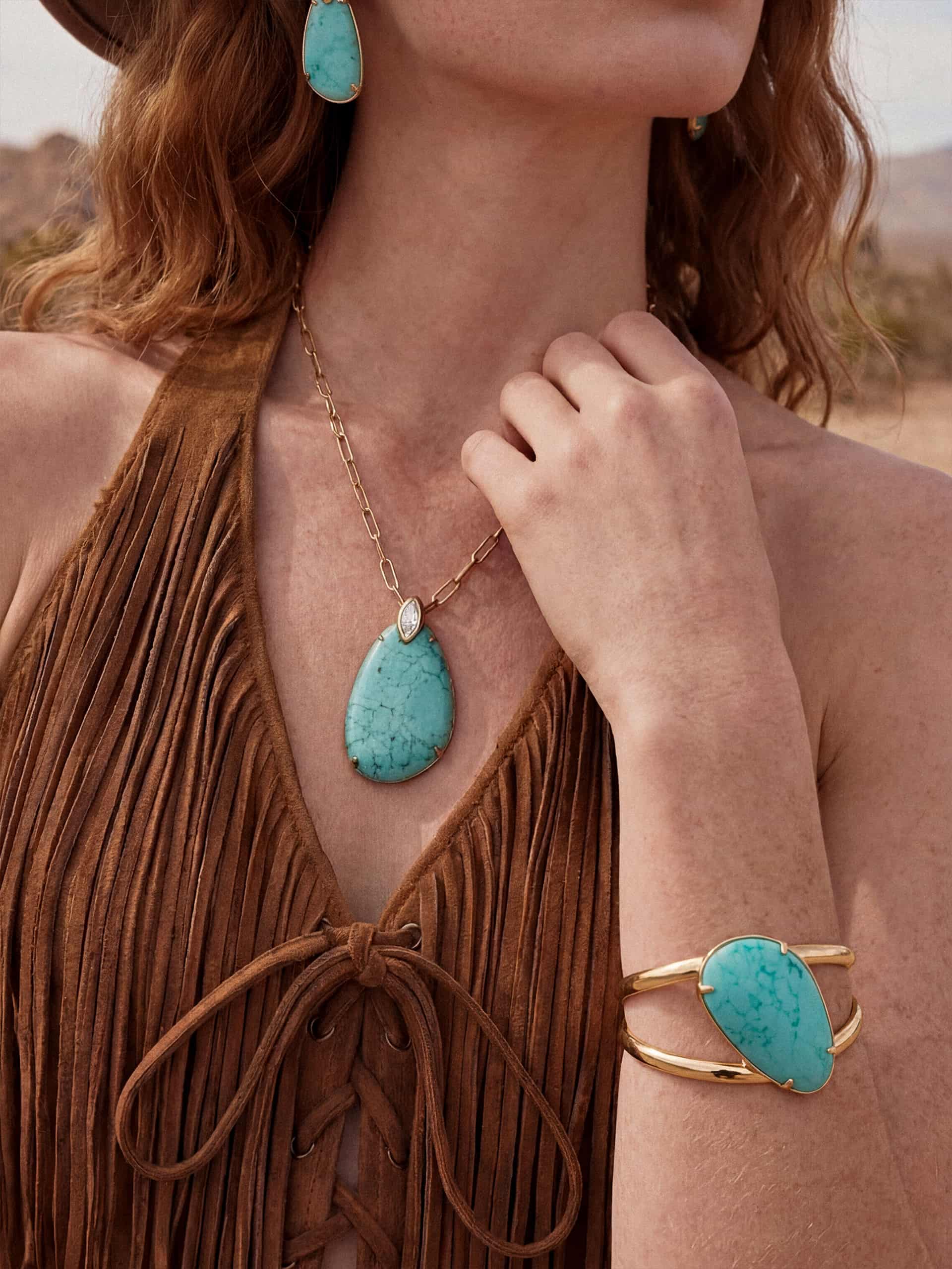 Model wearing turquoise pendant statement jewelry set