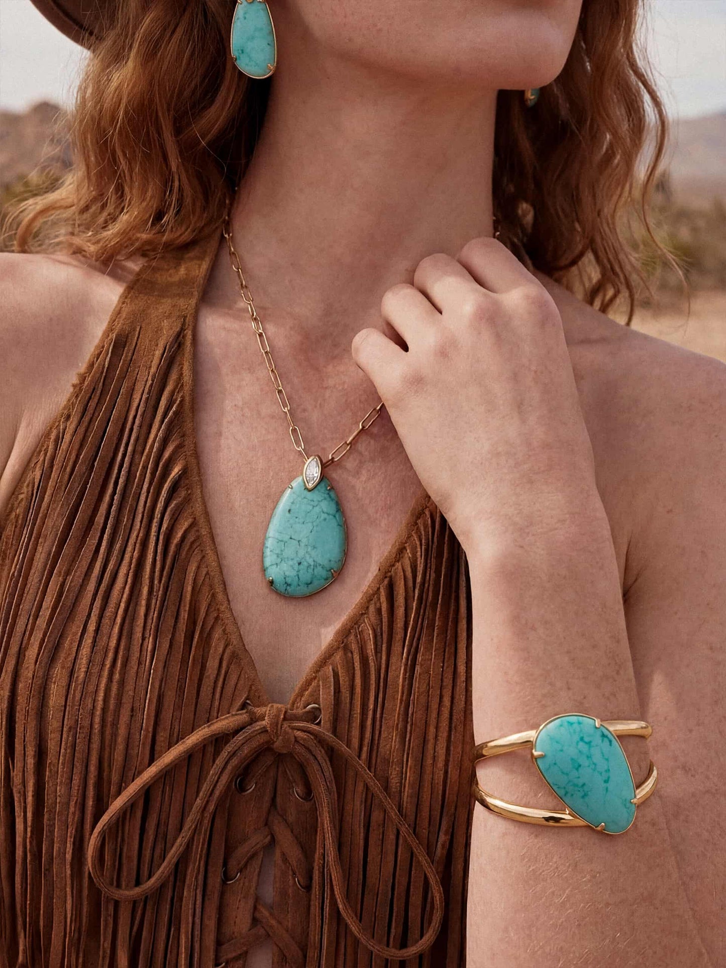 Model wearing turquoise pendant statement jewelry set