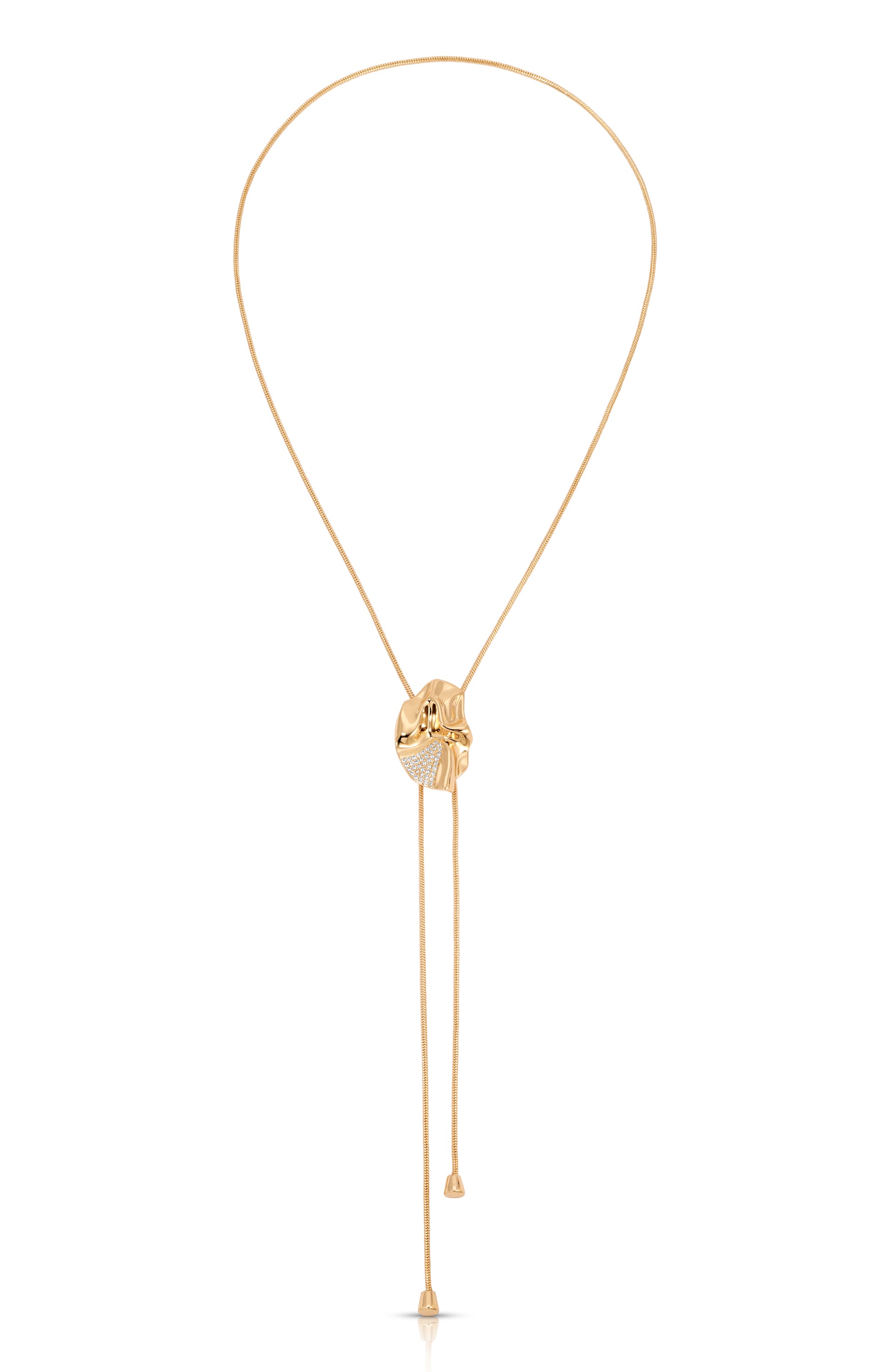 A delicate gold lariat-style necklace with a central oval pendant featuring a textured gold center and a halo of small clear stones, with two long dangling chains ending in small gold beads, shown on a plain white background.