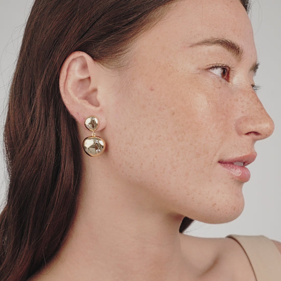 Polished Double Pebble Drop Earrings on model in video