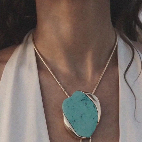 model at the ocean wearing bolo necklace