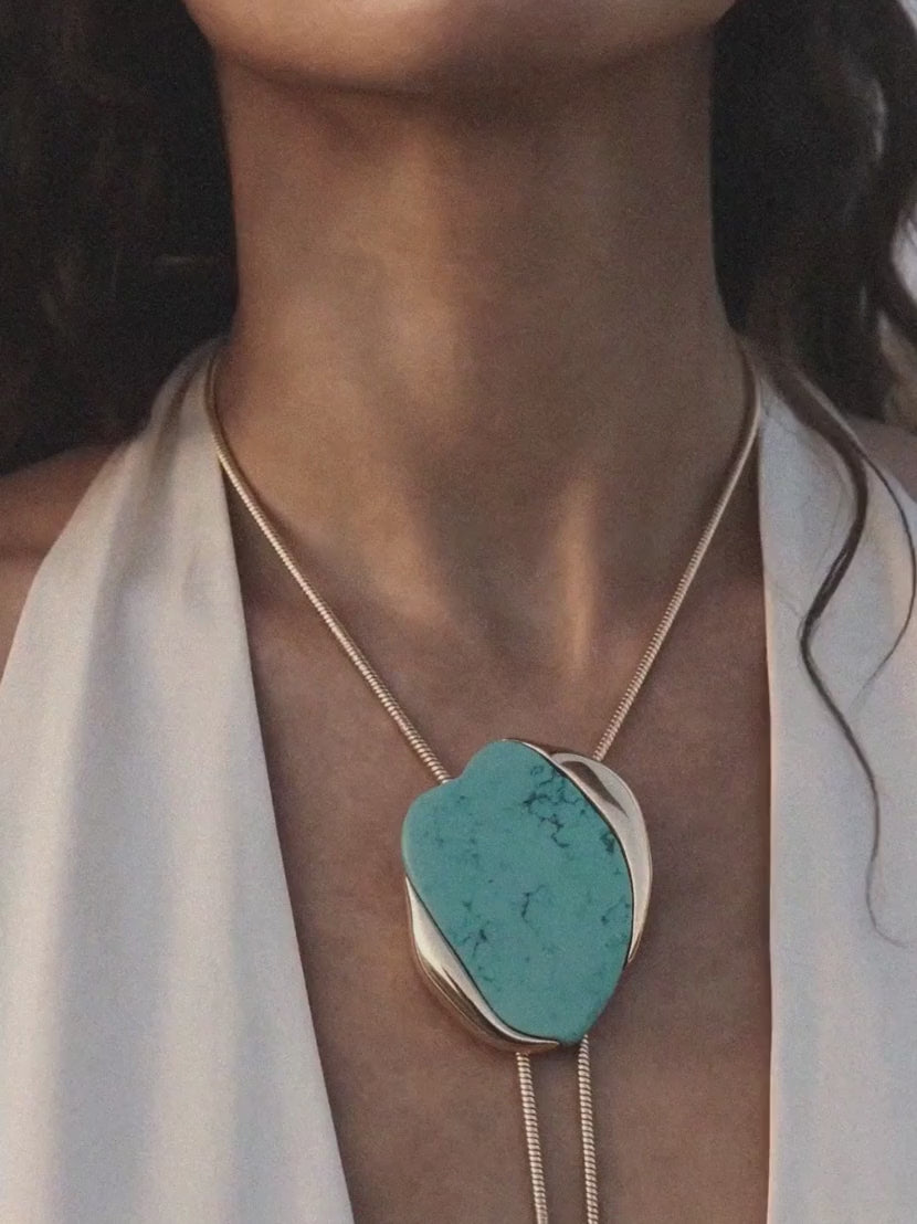 model at the ocean wearing bolo necklace