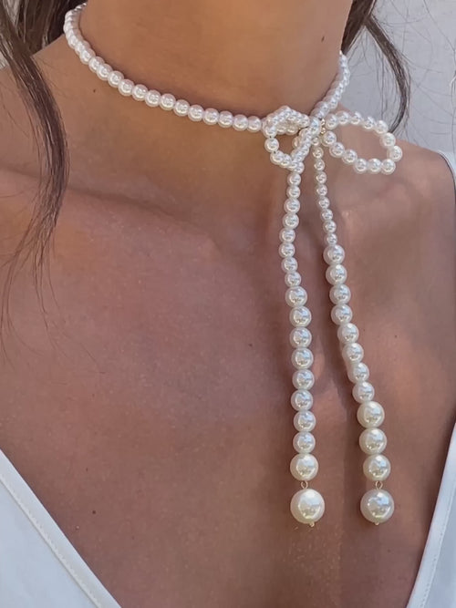 Venus Pearl Bow Necklace on model in video