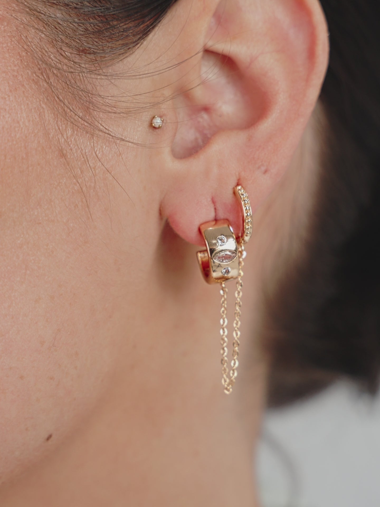 Double Piercing Bezel Crystal Dangle Earrings on model in video